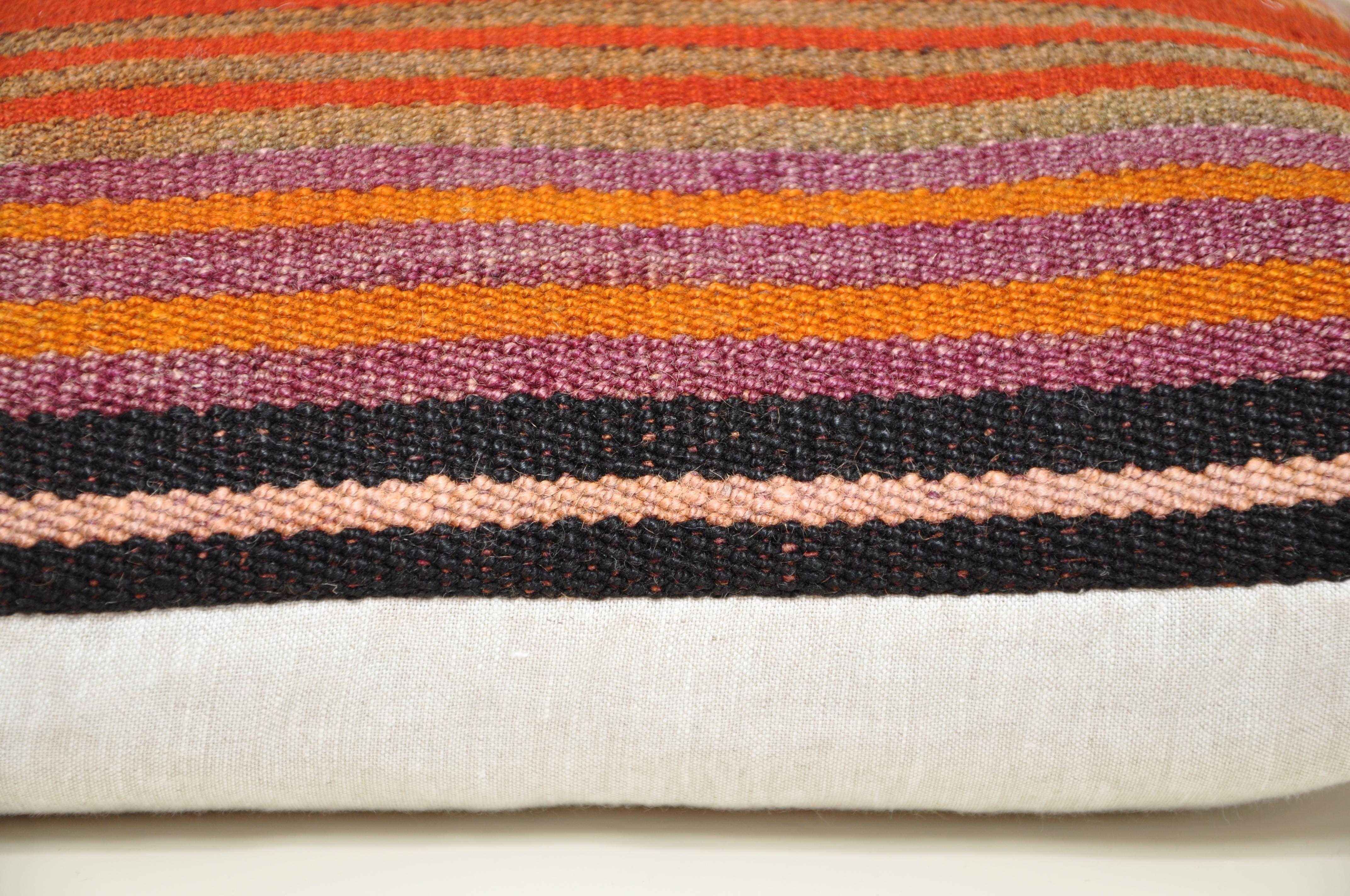 Luxury pillow created from an exquisite piece of vintage kilim rug combined with Irish Linen by Irish designer Katie Larmour. 

In rich, warm colours of orange, rust, purple, red and soft black. 

Each cushion is constructed in Ireland.
Filled with
