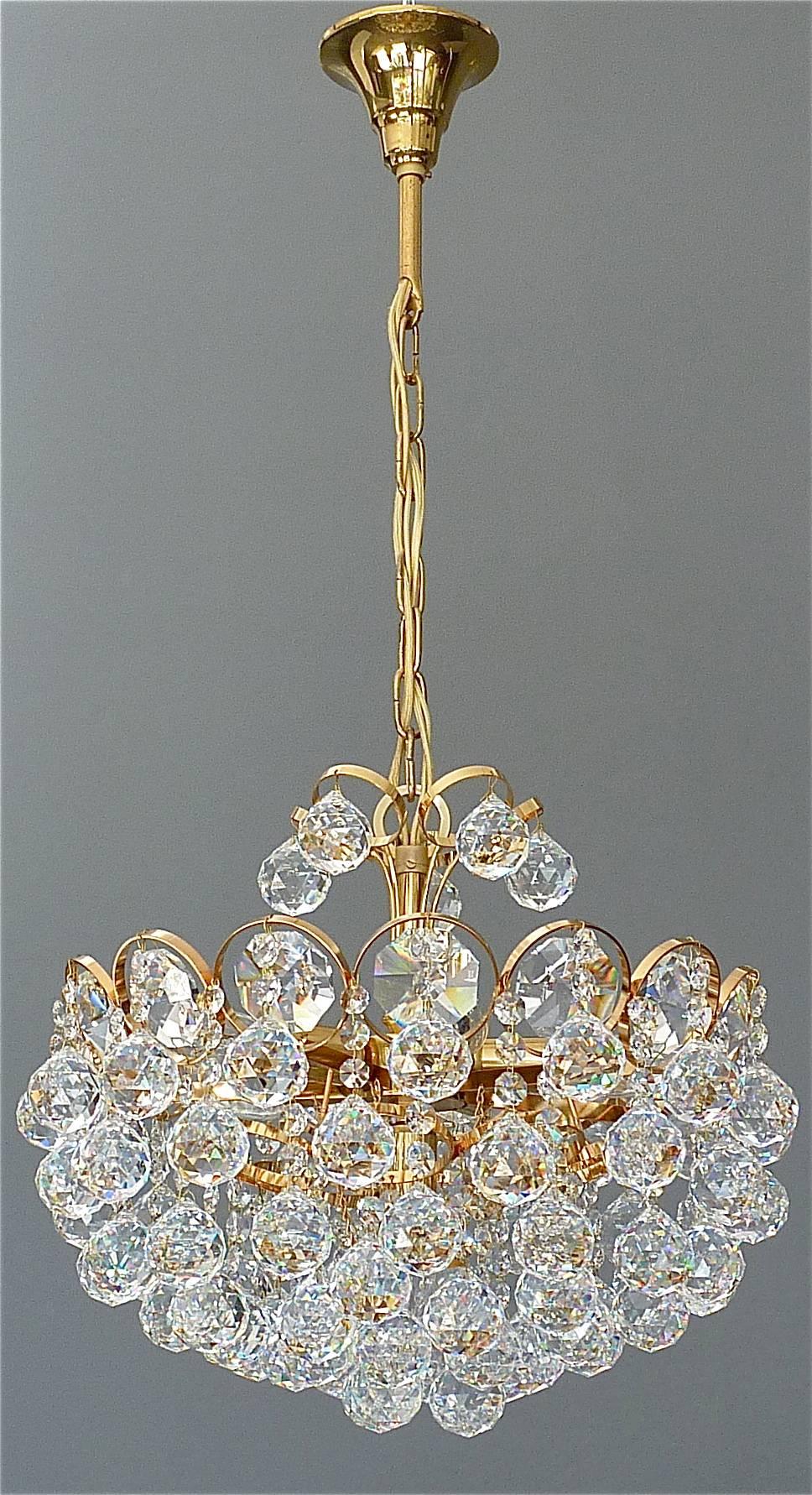 Precious gilt brass and crystal glass ball chandelier made by high class lighting company Palwa, Germany circa 1960-1970. The chain-hanging length-adjustable chandelier has a gilt brass metal construction with lots of high lead hand-cut faceted