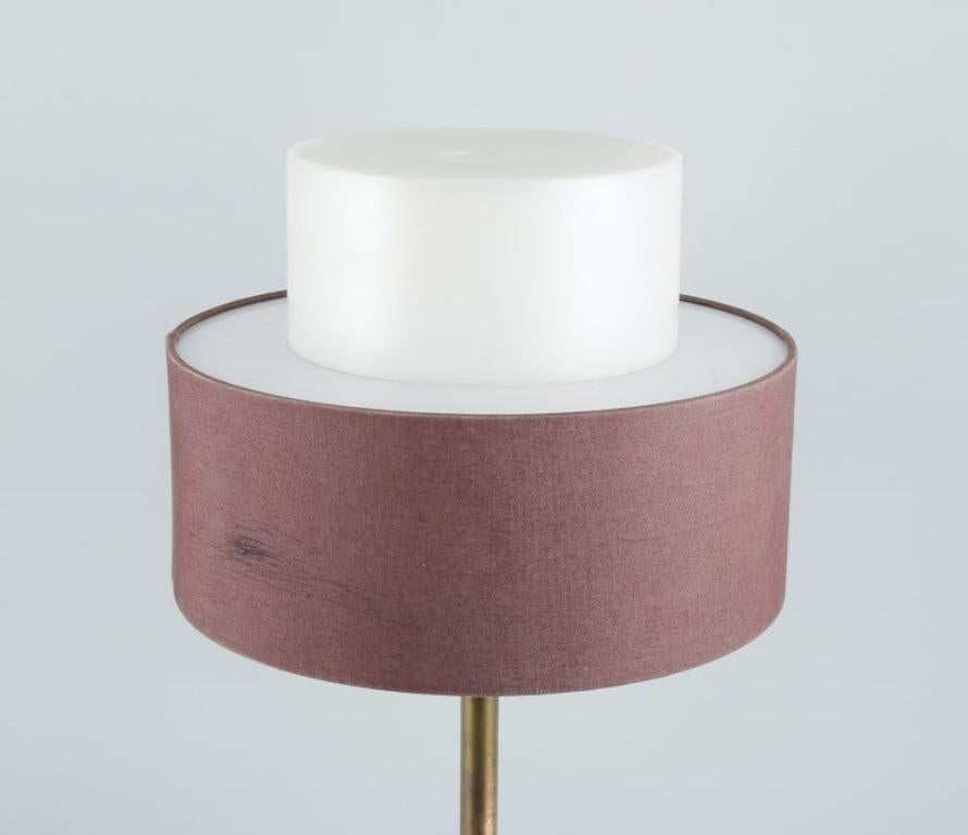 Swedish Luxus, Sweden. Large table lamp in brass, shade in plastic and brown fabric. For Sale