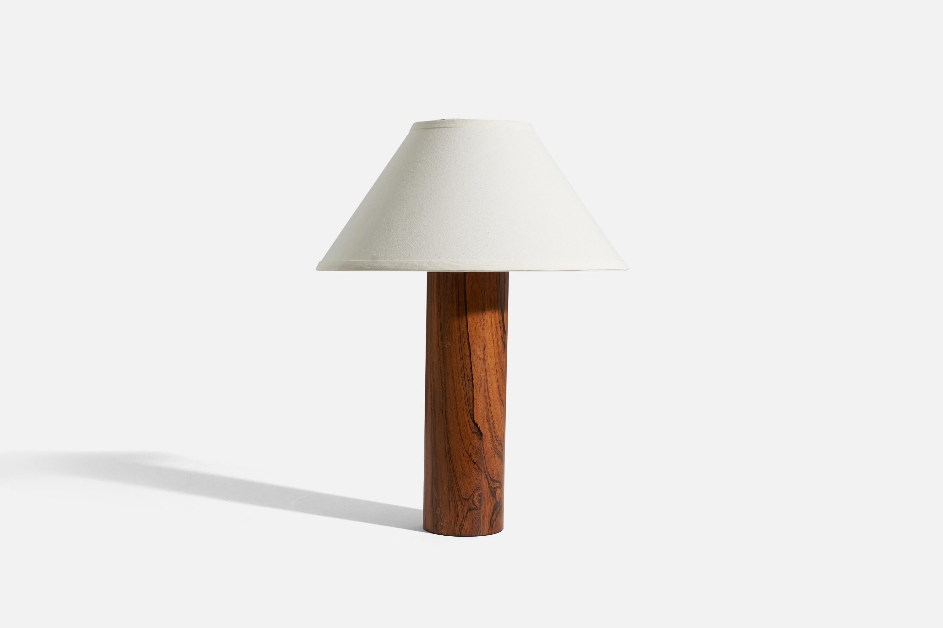 A rosewood table lamp designed and produced by Luxus Vittsjö, Sweden, c. 1960s.

Sold without lampshade. 
Dimensions of Lamp (inches) : 18.1875 x 4.25 x 4.25 (H x W x D)
Dimensions of Shade (inches) : 6.25 x 16.25 x 9.25 (T x B x H)
Dimension