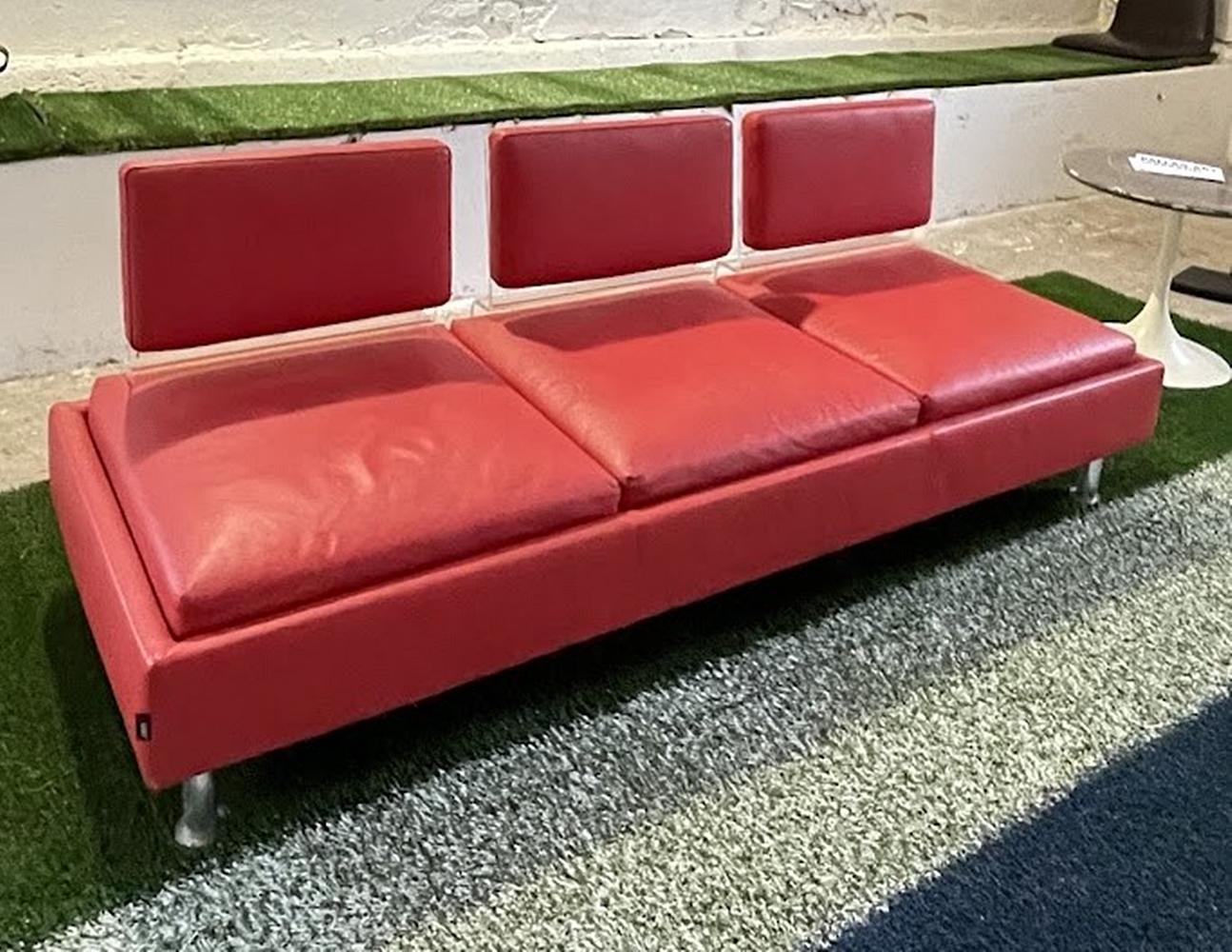 This elegant sofa upholstered in genuine bright red leather is an outstanding and particularly rare piece from the renowned Italian furniture manufacturer Luxy, embodying the company's nearly half-century tradition of design and craftsmanship.