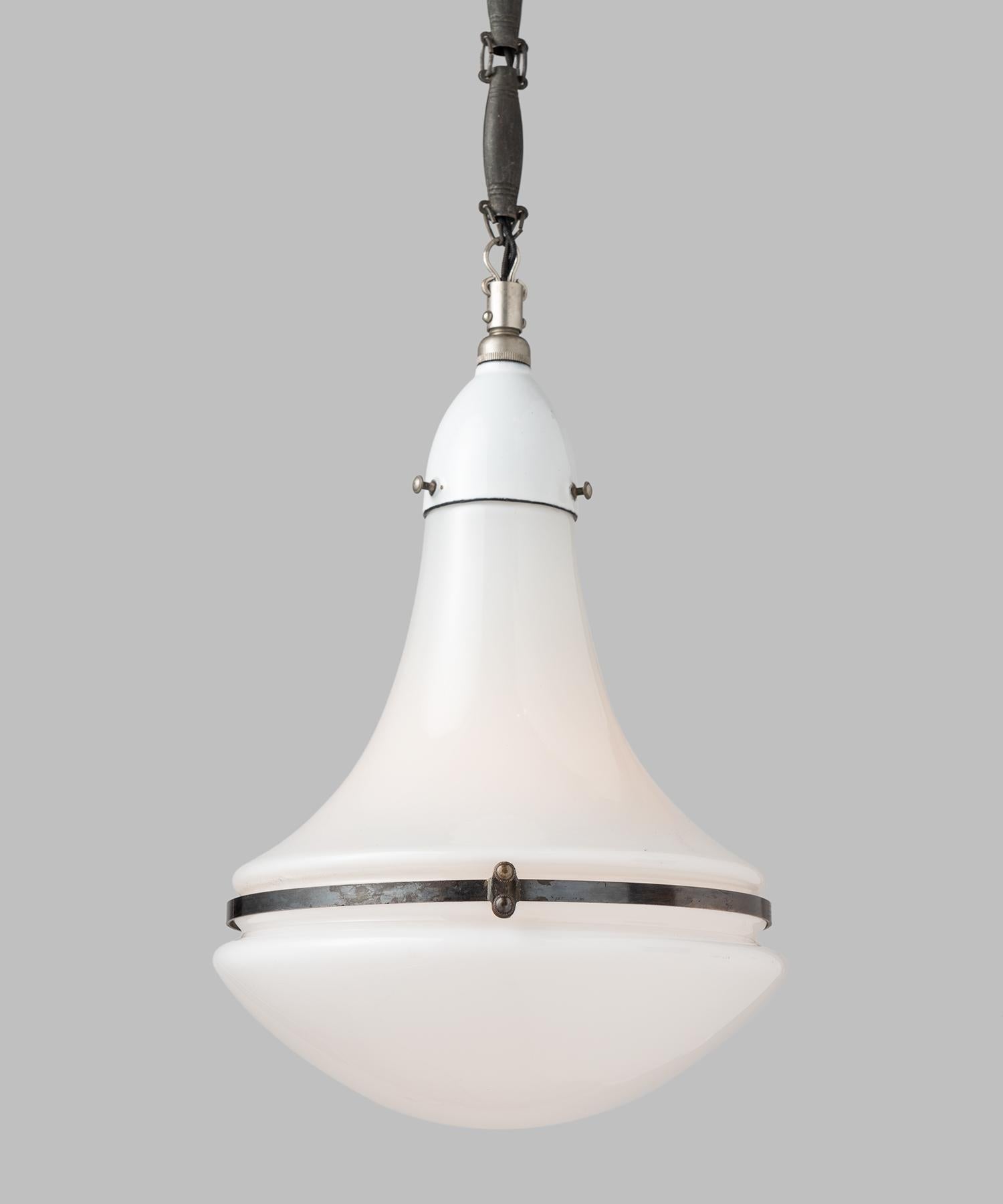 Luzette pendant by Peter Behrens, Germany, circa 1920.

Small pendant with opaline glass top and bottom, secured with enameled fitter and copper brace. Comes with original chain and canopy. Manufactured by AEG Siemens with manufacturer's mark.