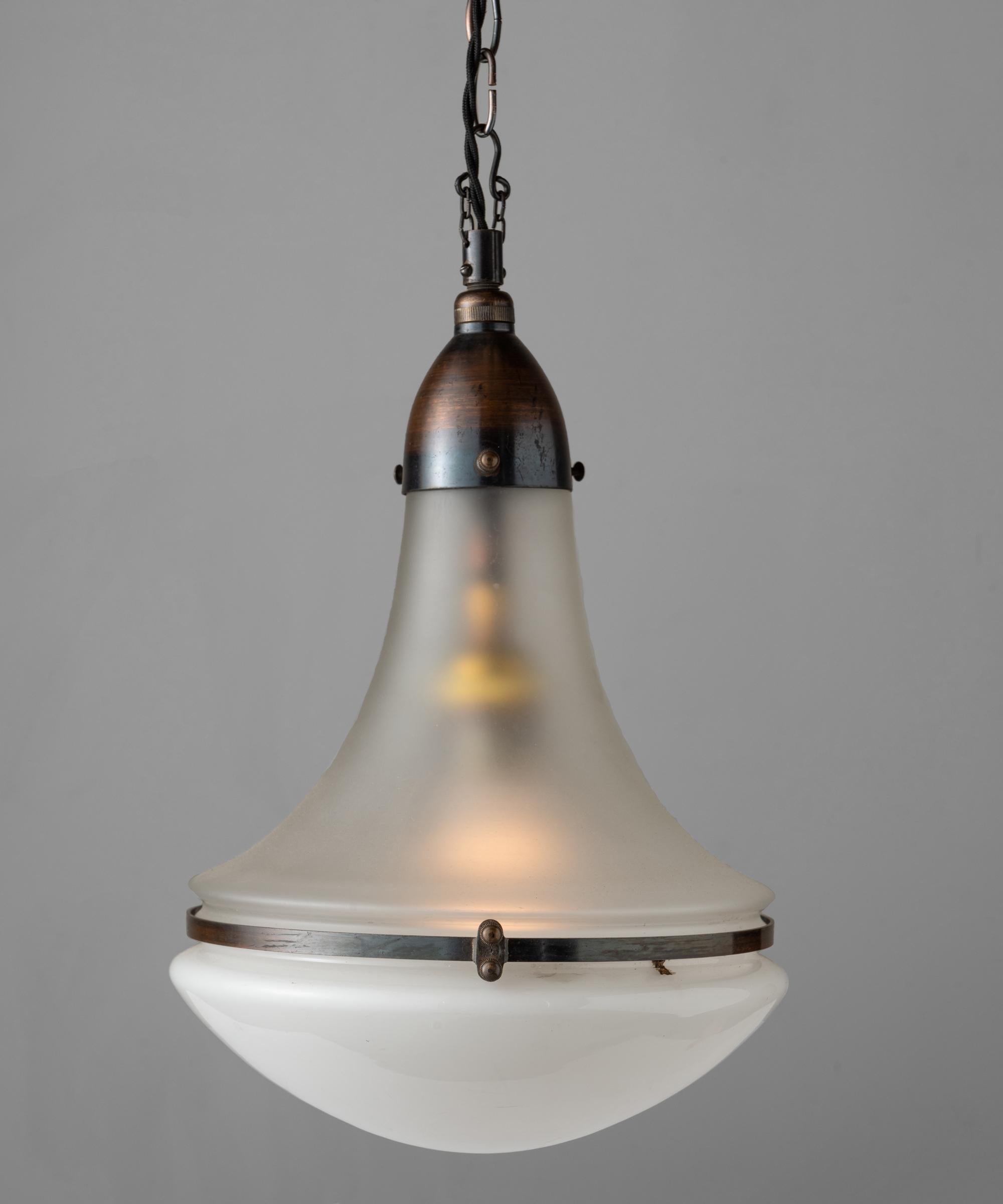 Luzette pendant by Peter Behrens, Germany circa 1930.

With frosted glass top and opaline glass bottom, secured with copper fitter and brace. Manufactured by AEG Siemens with manufacturer's mark.

Measures: 9