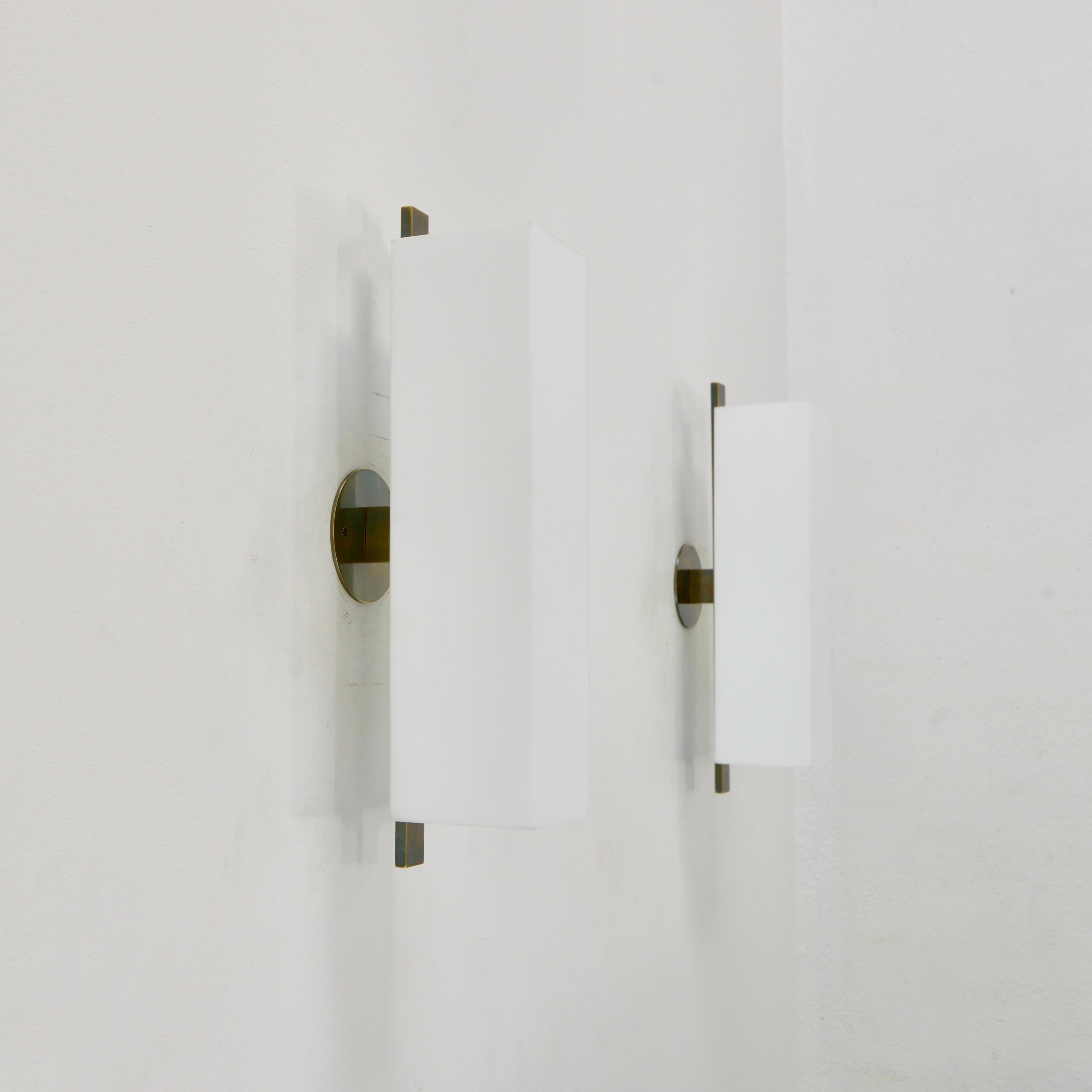 The LUZQT PB sconce by Lumfardo Luminaires is a fabulous and stunning, large brass and square tubular blown glass sconce finished in patinated brass.
Please inquire for lead time.
Measures: Fixture height 19”
Depth 6.5”
Width 4” 
Shade dimensions