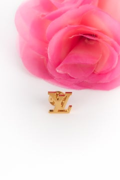 Spille LV in metallo dorato