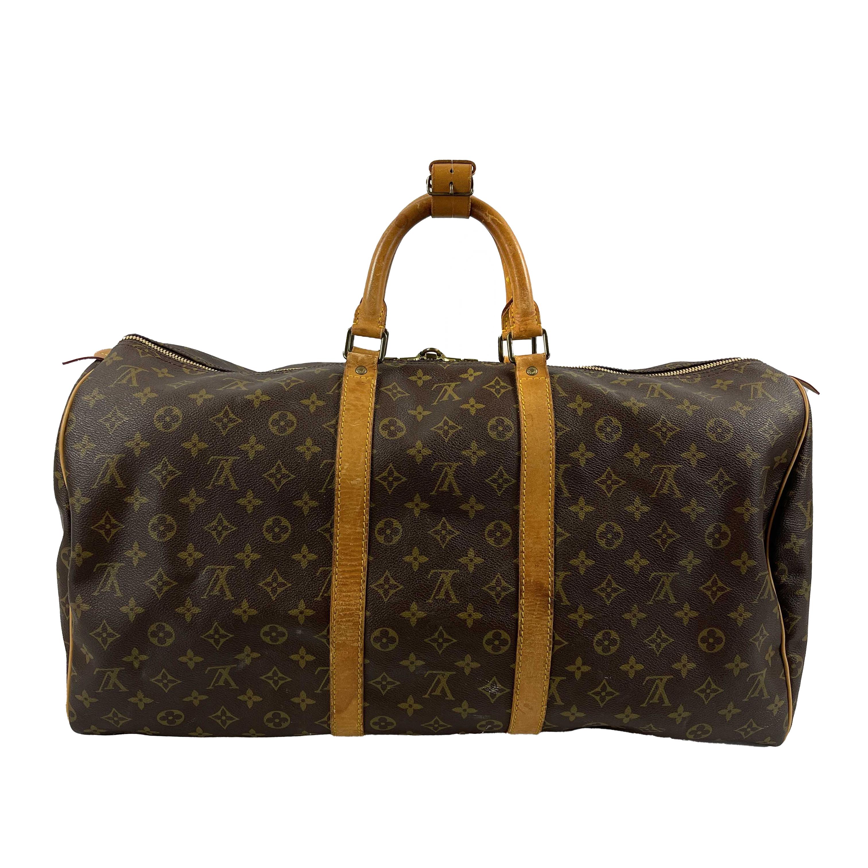 LV Louis Vuitton - VTG 1985 Brown Beige Monogram - Keepall 50 Large Duffle Bag 

Description

This vintage Louis Vuitton Keepall 50 duffle bag was manufactured in February 1985 (date code: 852 SD).
It is crafted with the iconic brown and beige LV