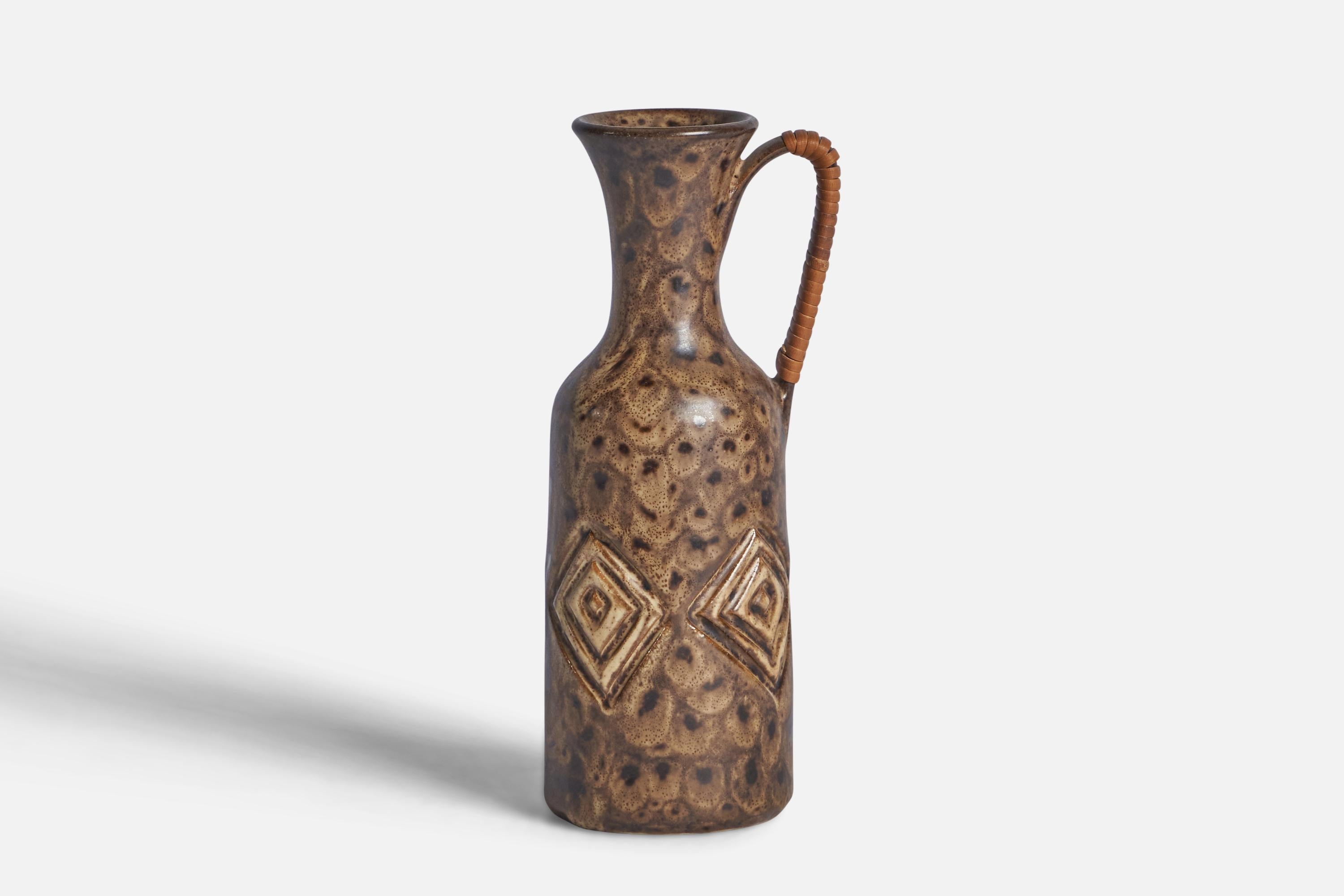 A brown-glazed incised stoneware pitcher designed and produced by Løvemose, Denmark, c. 1960s.