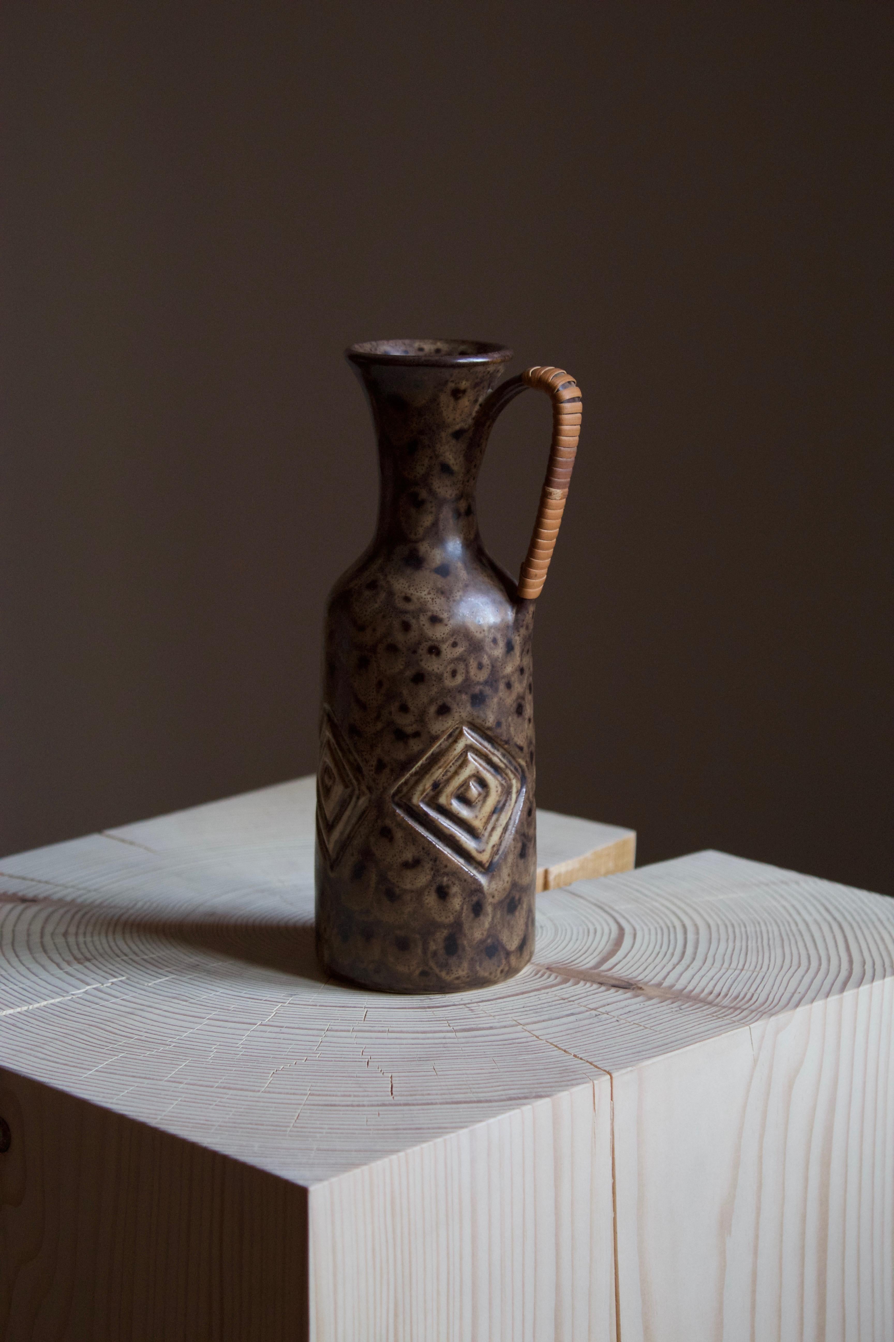 A small pitcher produced and designed by Løvemose, Denmark, 1960s. With makers stamp

Other ceramicists of the period include Axel Salto, Arne Bang, Carl-Harry Stålhane, and Berndt Friberg.