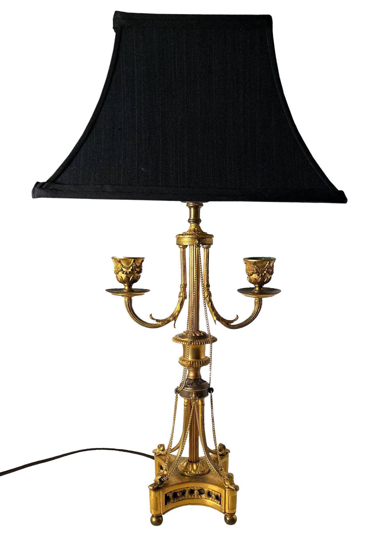 A fabulous pair of LVI style bronze dore candelabras mounted now as lamps with chains attached. With black rectangle shades. Circa, 1860 France.