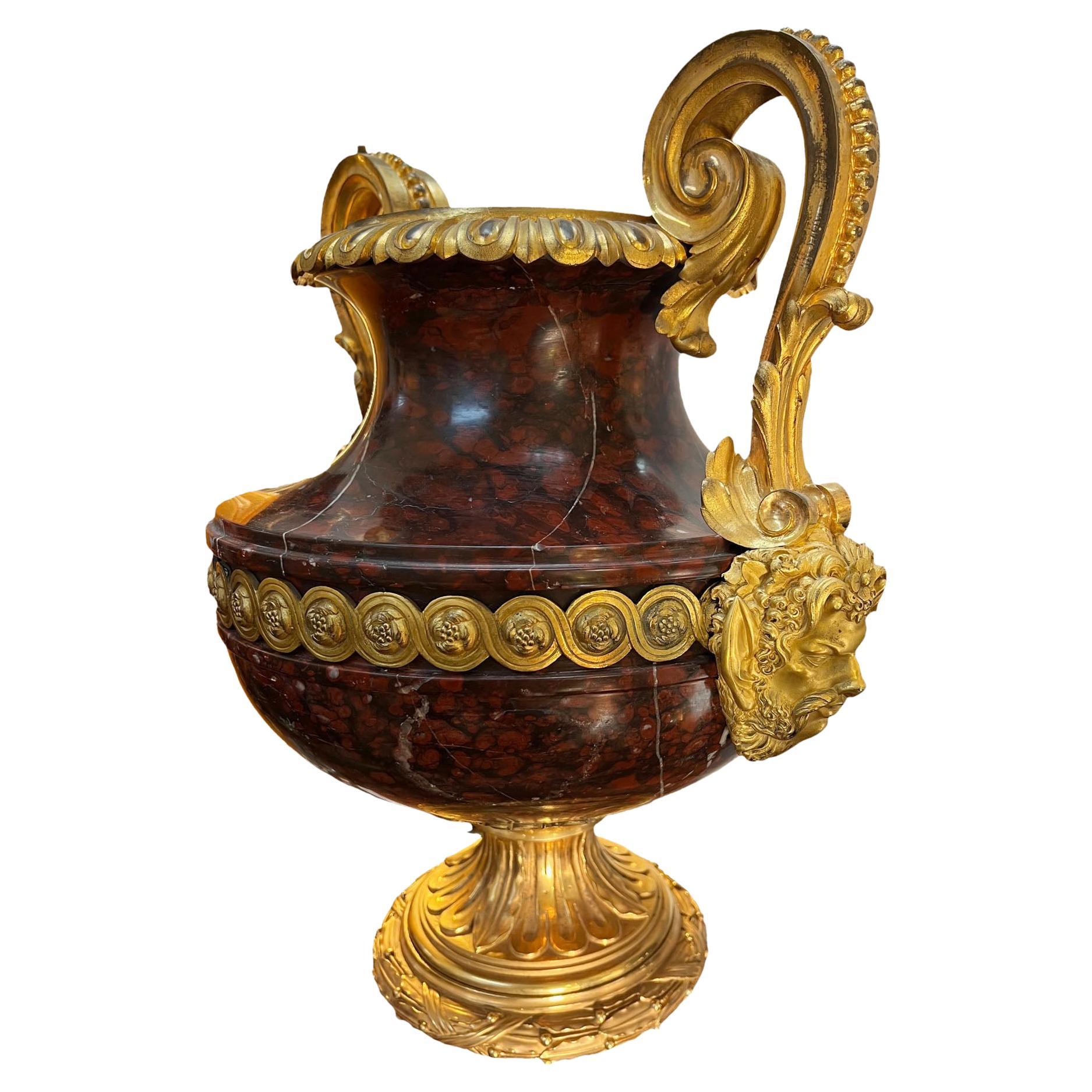 Large marble urn with curved two handled arms and well detailed bronze dore faces. Mark different from base marble. 19th century, Italy. Urn only is nineteen and three quarters inches high.