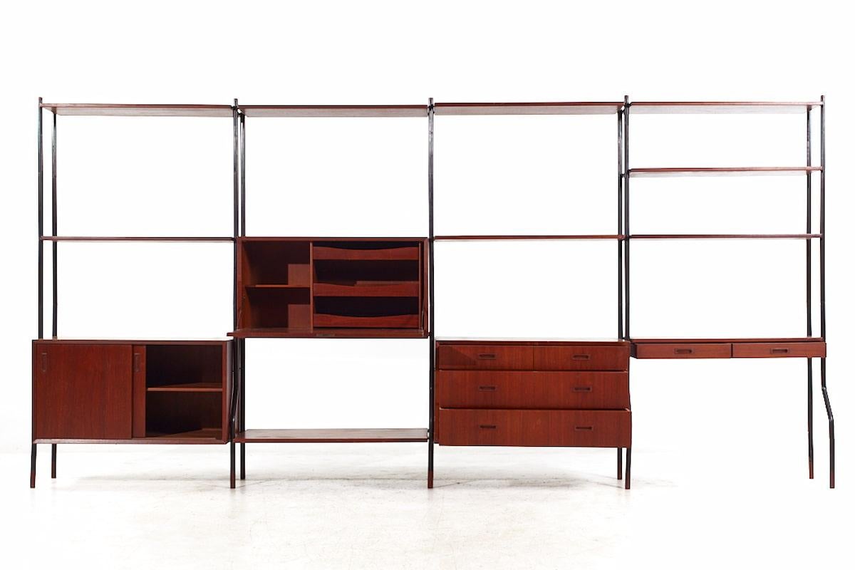 Lyby Mobler Mid Century Danish Teak and Steel 4-Bay Freestanding Wall Unit

This wall unit measures: 147 wide x 17 deep x 72.5 inches high, with a chair clearance of 24 inches

All pieces of furniture can be had in what we call restored vintage