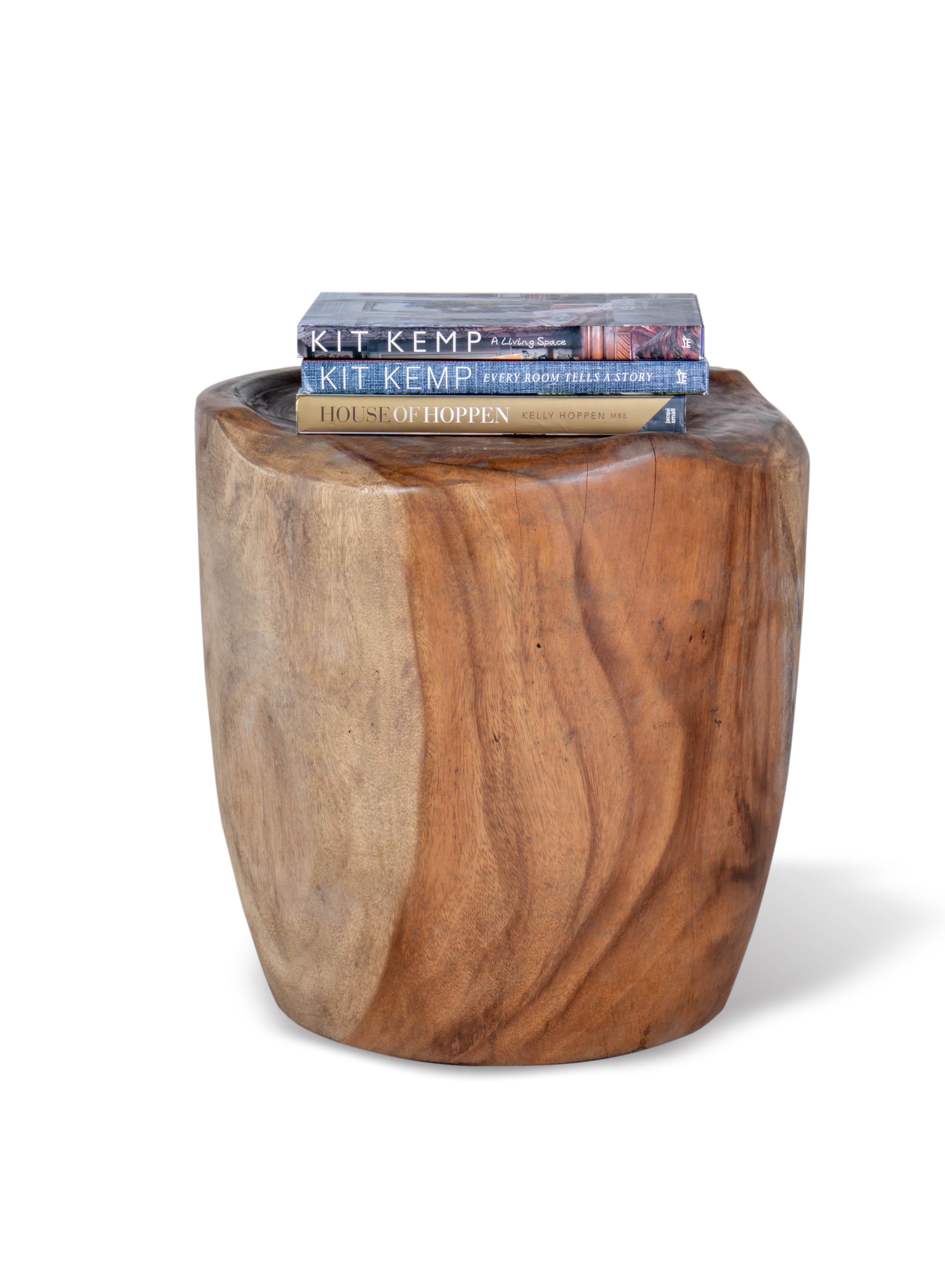 This is a stool that is made out of a solid piece of lychee wood. It has been sculpted into a beautiful and smooth base and comforable seat. The stool is perfect for use as a side table or as extra seating in a living room or bedroom. It would also