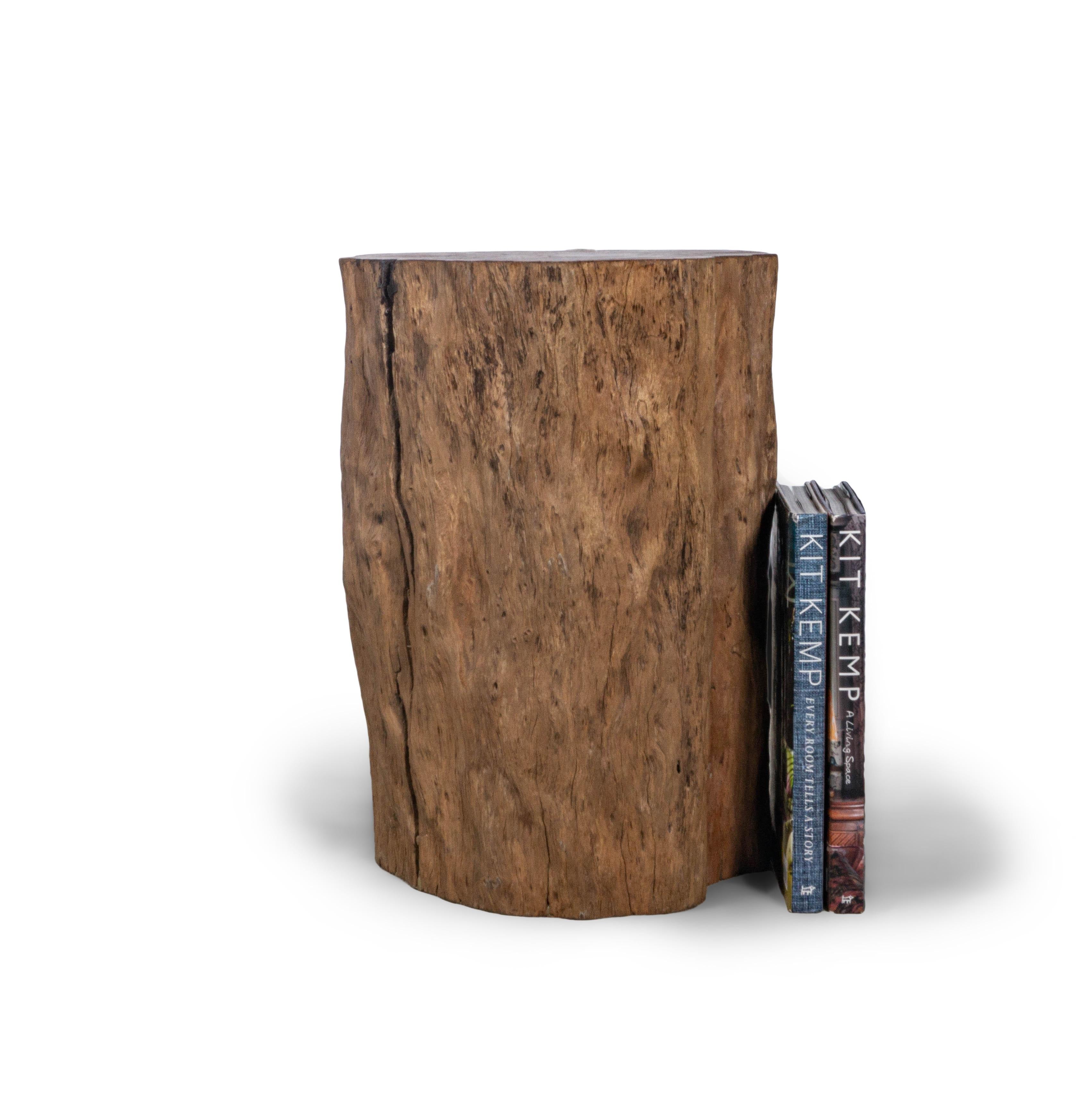 This organic form lychee wood side table offers a one of a kind shape found only in nature making it the perfect way to bring the outdoors in. Offering a beautiful cider toned hue, this lychee wood side table is also a great way to ad warmth into