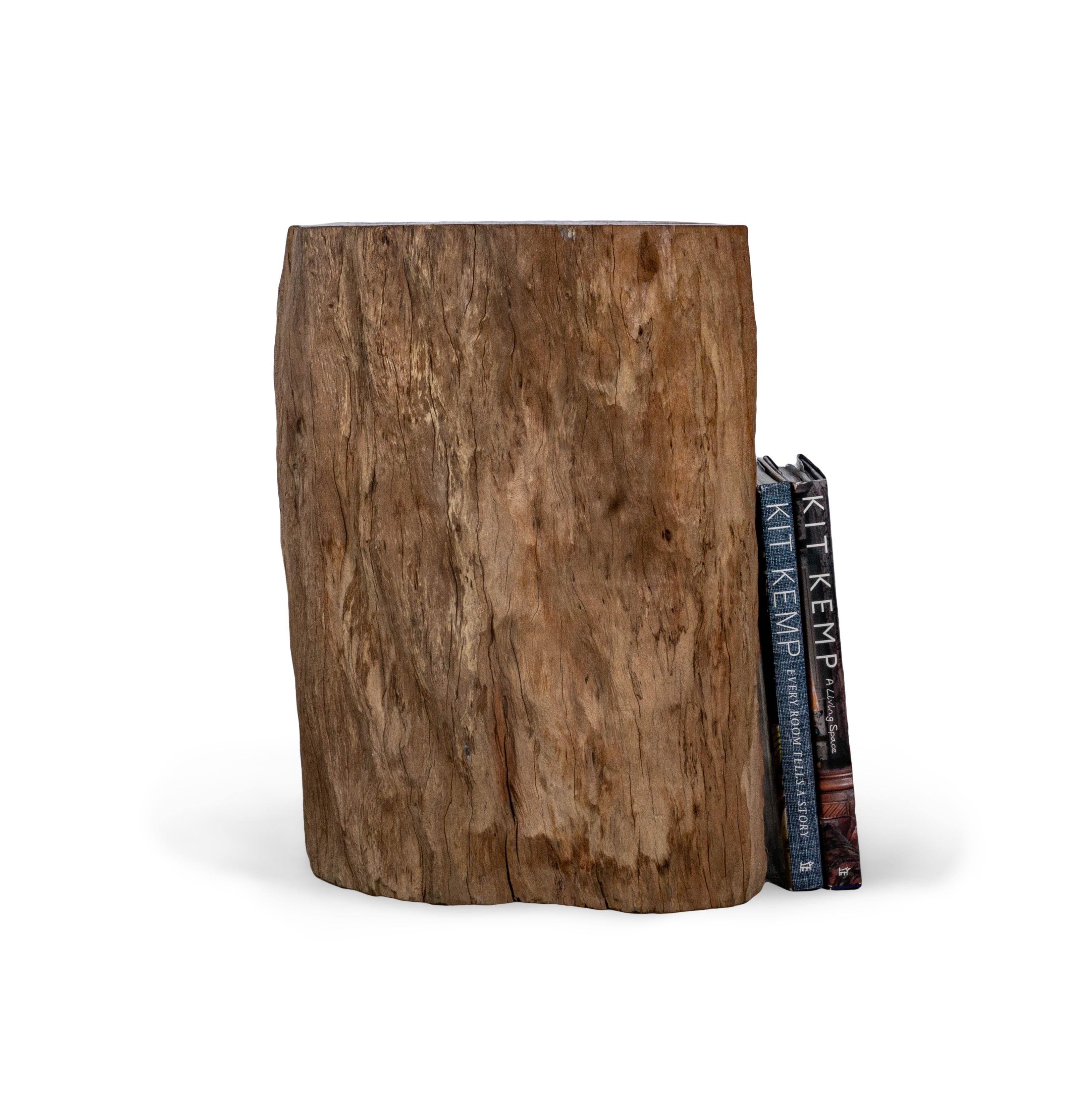 This organic form lychee wood side table offers a one of a kind shape found only in nature making it the perfect way to bring the outdoors in. Offering a beautiful cider toned hue, this lychee wood side table is also a great way to ad warmth into