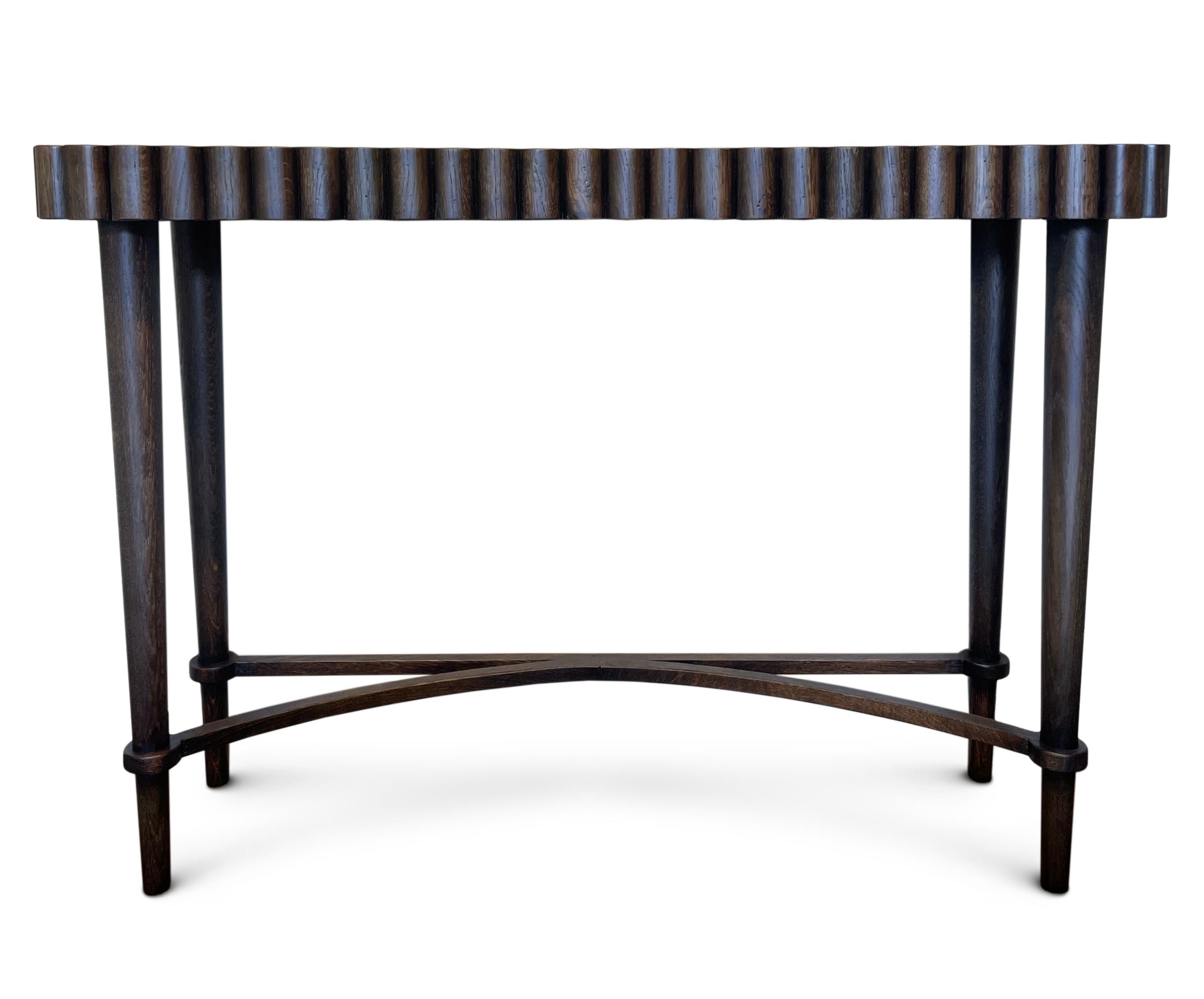'Lyddington' Console Table with curvy design available in various sizes & finishes.
Made in the UK, Hand crafted in Oak & hand polished.
Inverted box shaped top with curved decoration, on slender rounded tapering legs joined by a semi-elliptical