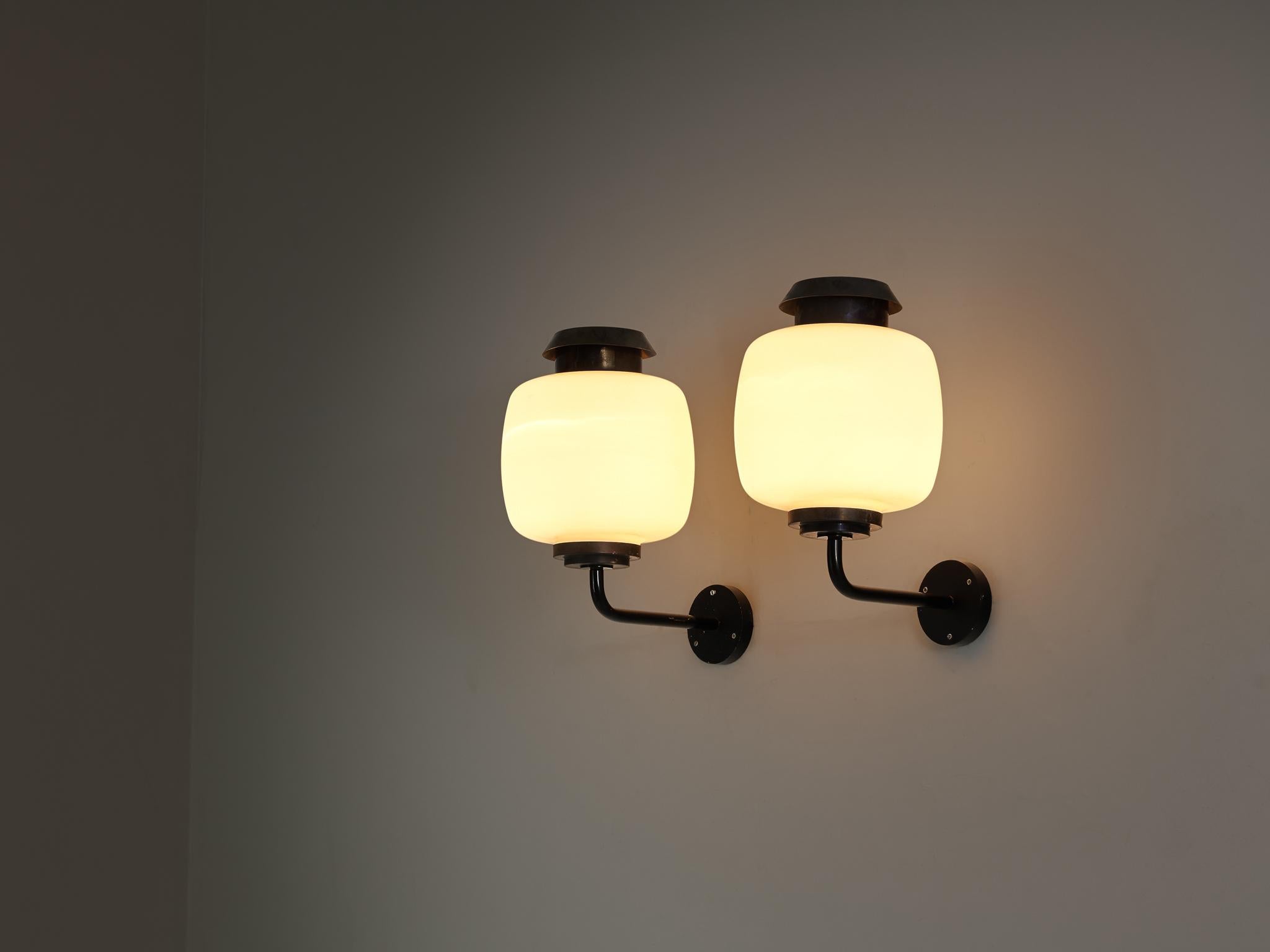 Lyfa, 'Drabant' wall lights, glass, copper, coated steel, Denmark, 1950s/60s

This elegant set of wall lights, made by the Danish lighting company Lyfa, likely dates back to the mid-20th century. Each lamp features a beautiful, spherical shade made