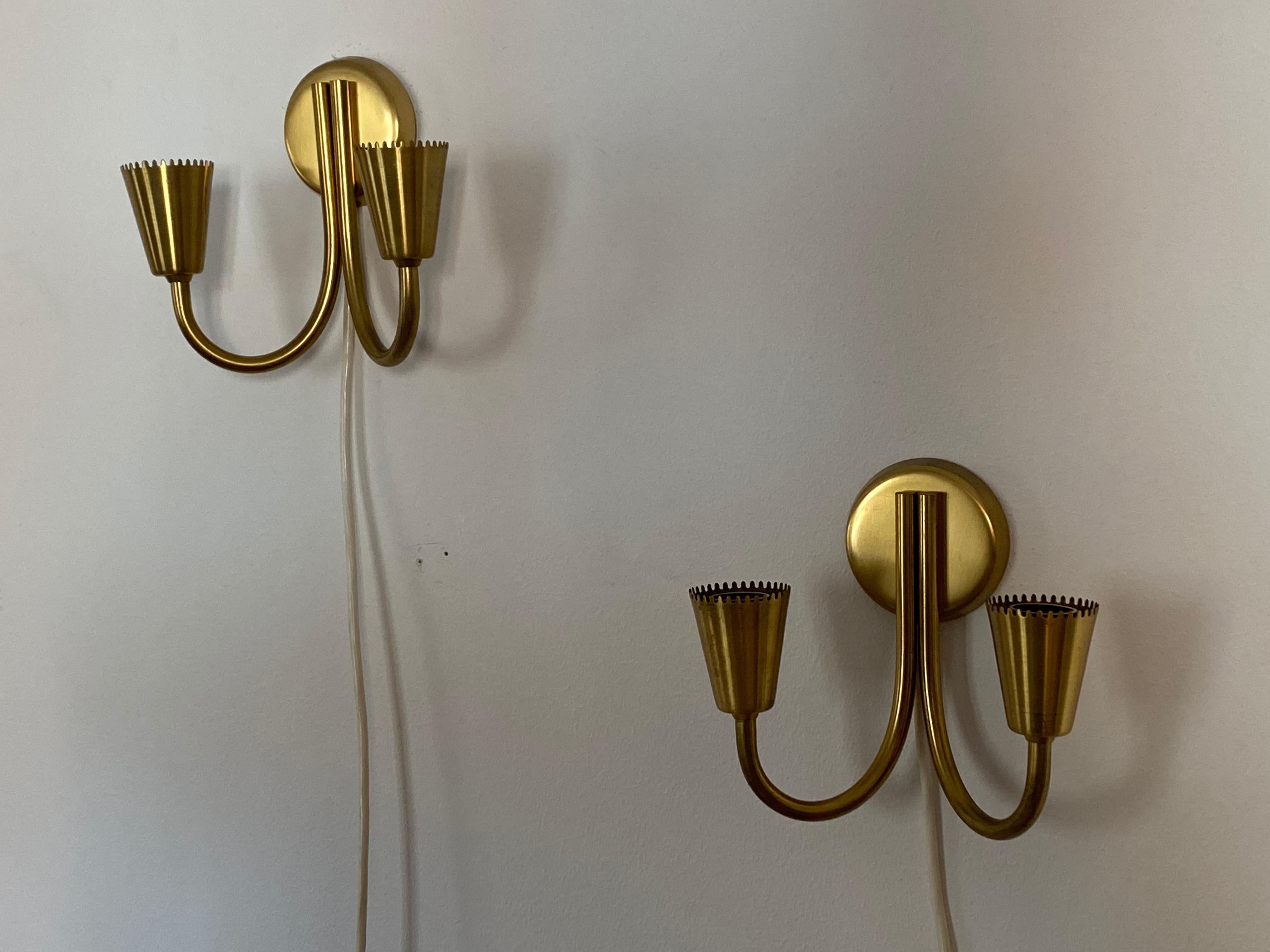 A pair of two-armed wall sconces / wall lights, designed and produced by Lyfa, Denmark, 1950s. Originally mounted with glass shades, now with brand new linen lampshades. 

Other designers of the period include Paavo Tynell, Jean Royère, Josef