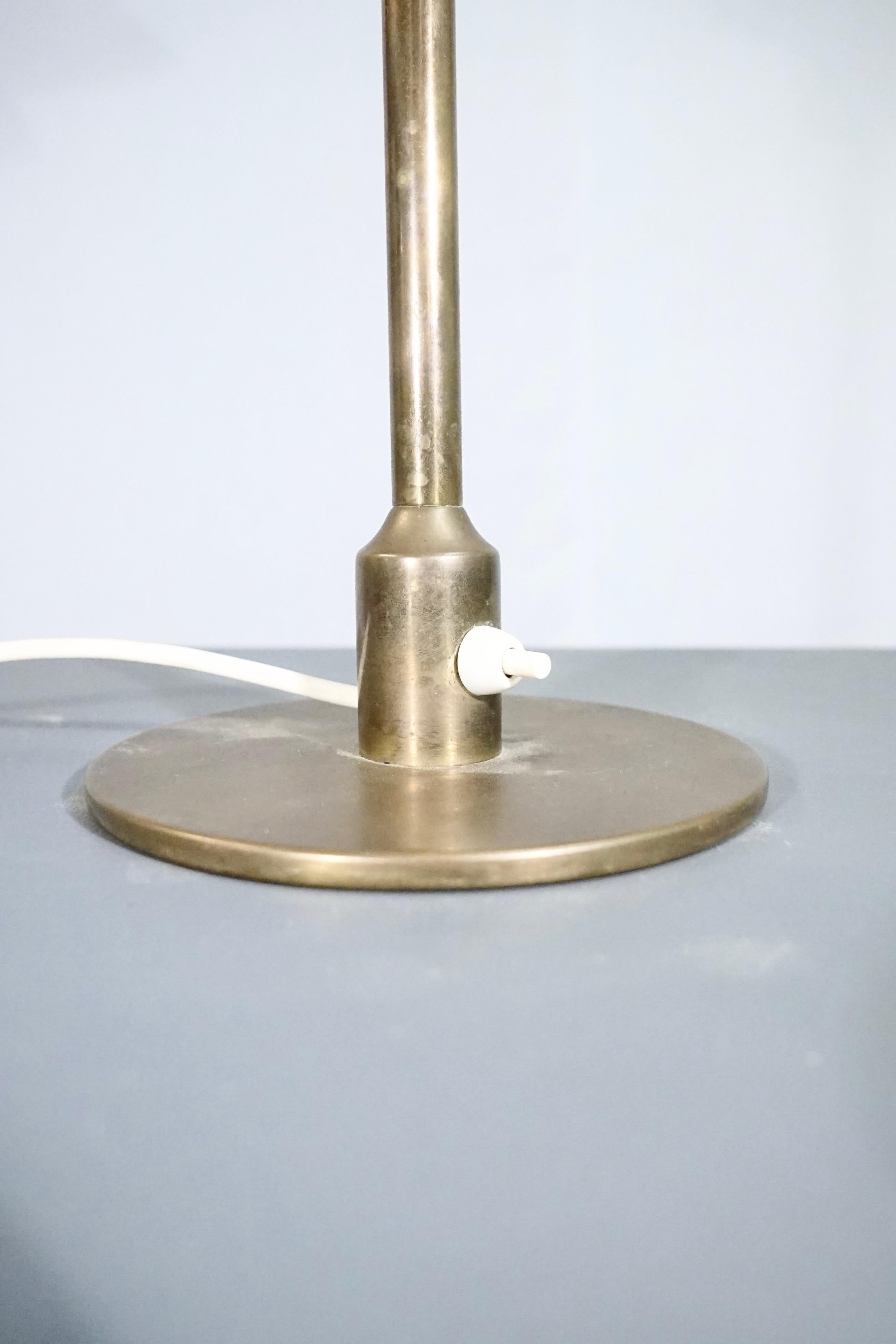 Rare and important Lyfa table lamp in patinaed brass with mat glass shade with a patinaed brass edge.

This model is a variation of model AP20, the difference between this model and the regular model AP20 is the switch on the foot of the
