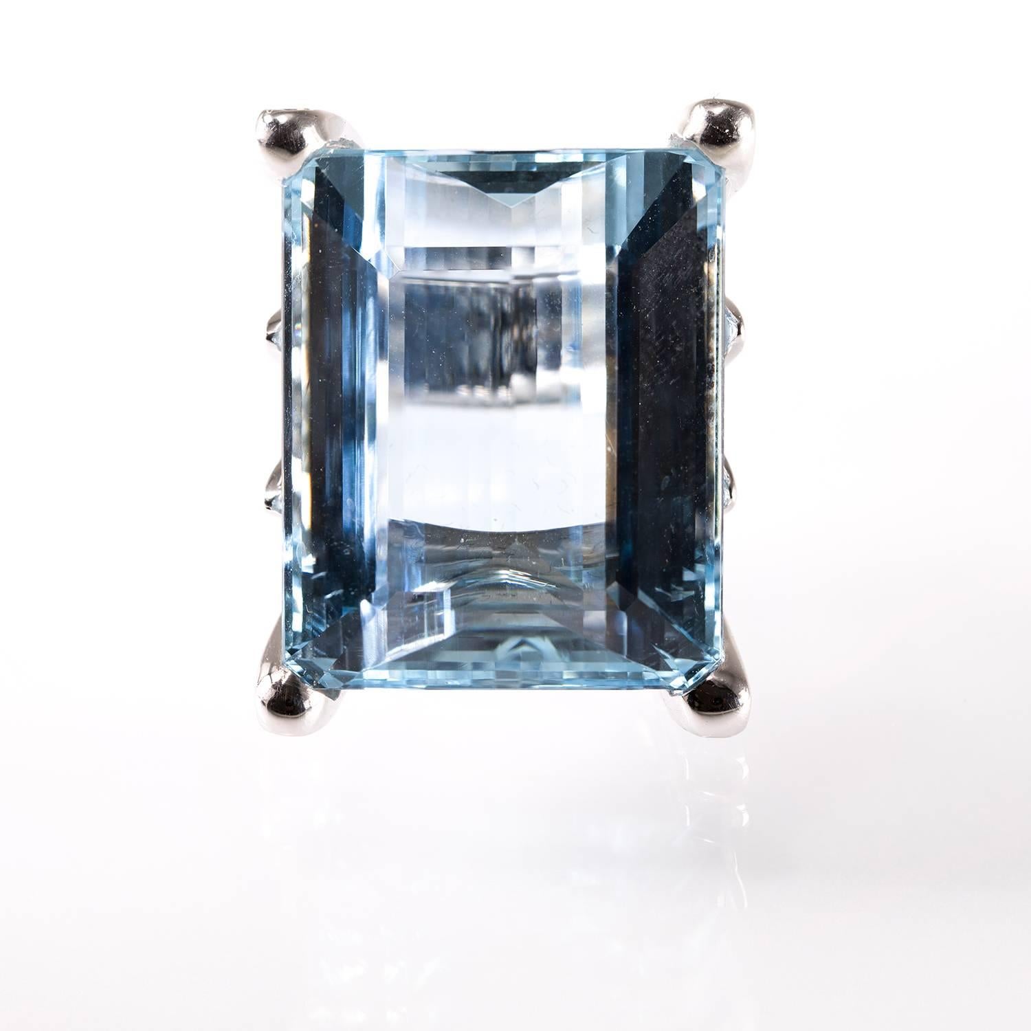 Exquisite One of a Kind 18kt white gold Ring center set with an emerald cut Aquamarine 47ct, transparent, bright intensity, gorgeous sky blue color, excellent cut and polish, pure without any inclusions. The Aquamarine is set between 4 18kt white