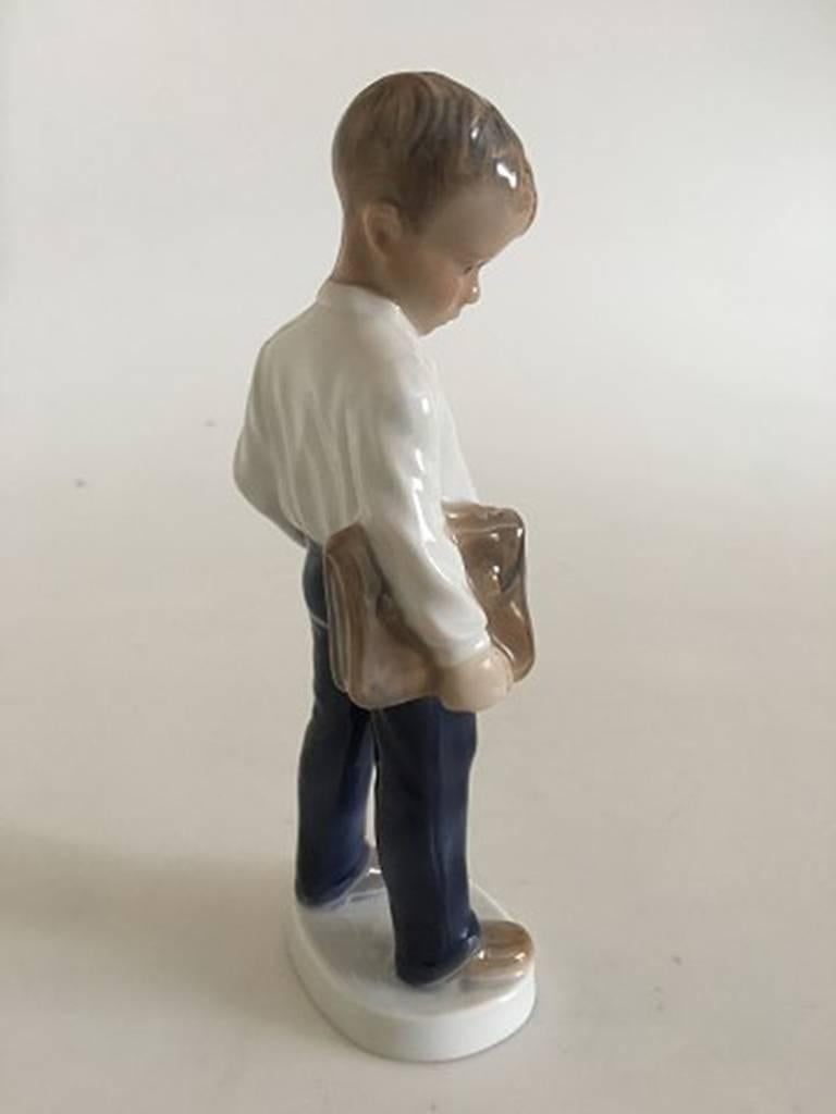 Lyngby porcelain figurine of a school boy. Measures 19cm. In perfect condition.