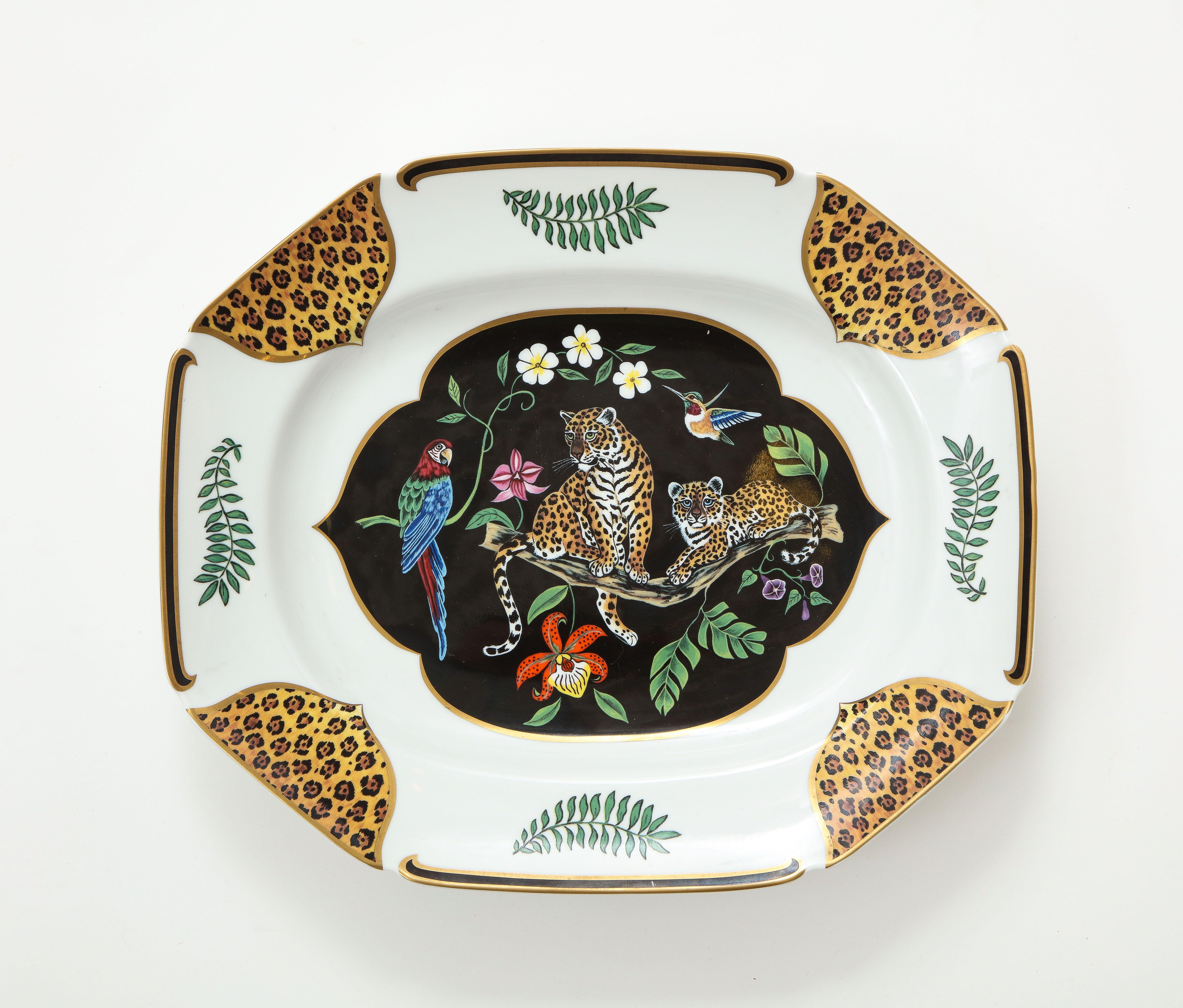 A set of great dinnerware by Lynn Chase. Jaguar Jungle is a wonderful pattern with animals surrounded by lush foliage and gilded in 24 k Gold. Six place settings and a platter. Measures: 1.5 x 8 x 6 in.