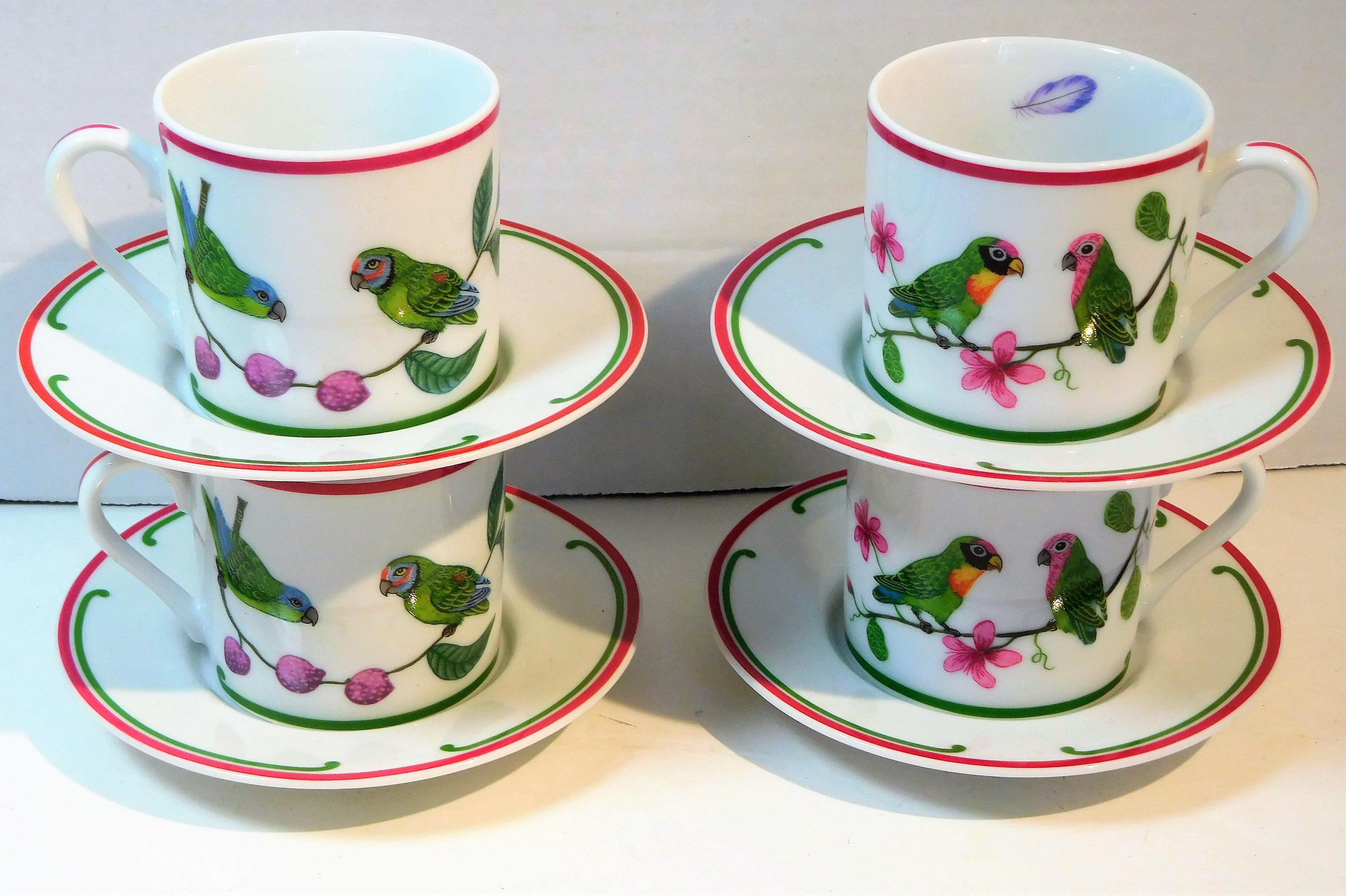 This colorful set of four porcelain demitasse cups and saucers ( 8 pieces total) was made by Lynn Chase Designs, Inc. of Massachusetts in 1989. The colors include green, fuchsia, orange, red, purple. blue and black on a white ground, so the colors