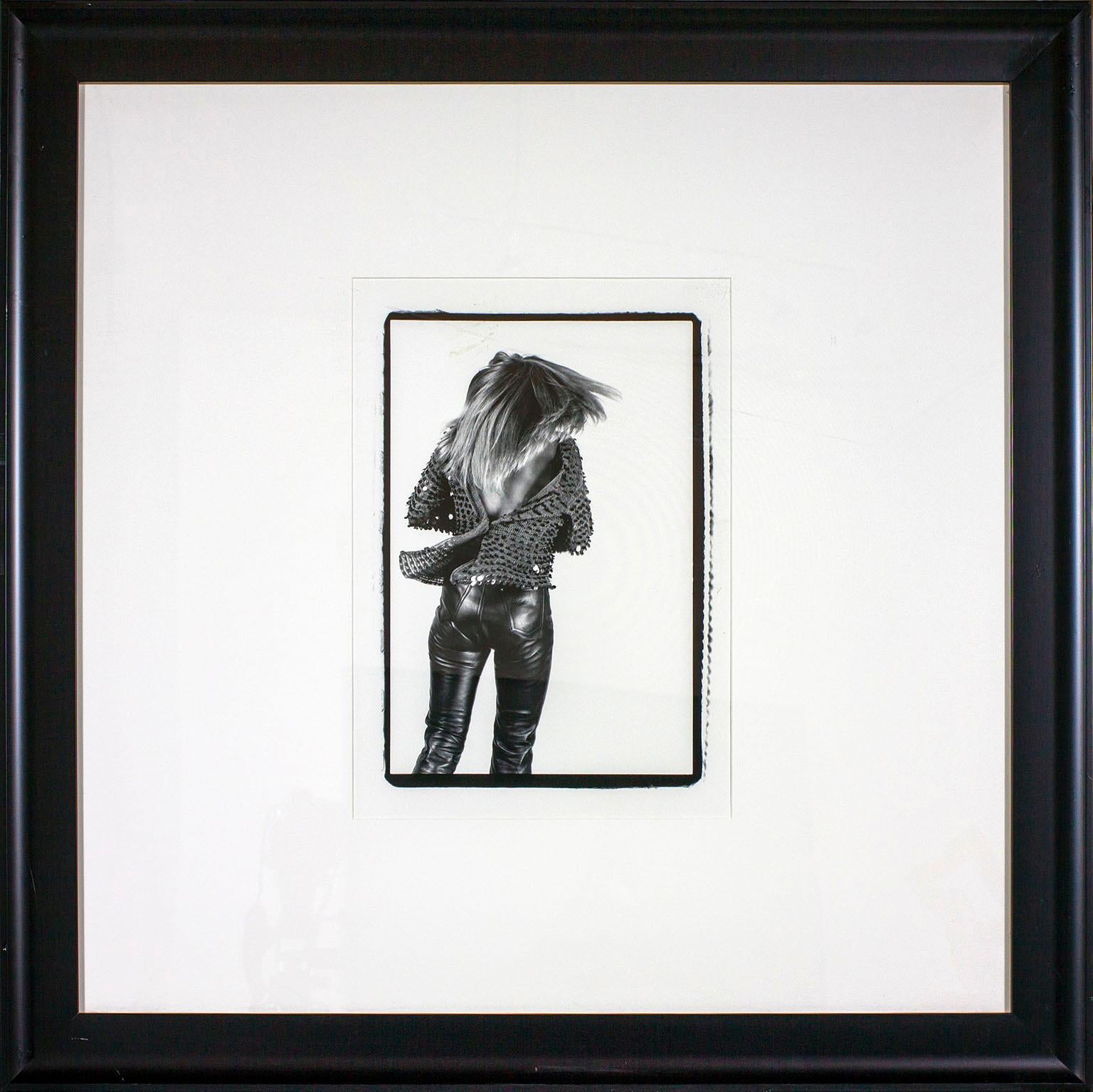 "Tina Turner 'The Back'" framed black and white photograph by Lynn Goldsmith. Image size: 16 3/4 x 11 inches. This photograph was previously displayed in a guest room of the original Hard Rock Hotel and Casino in Las Vegas, Nevada, and comes with a