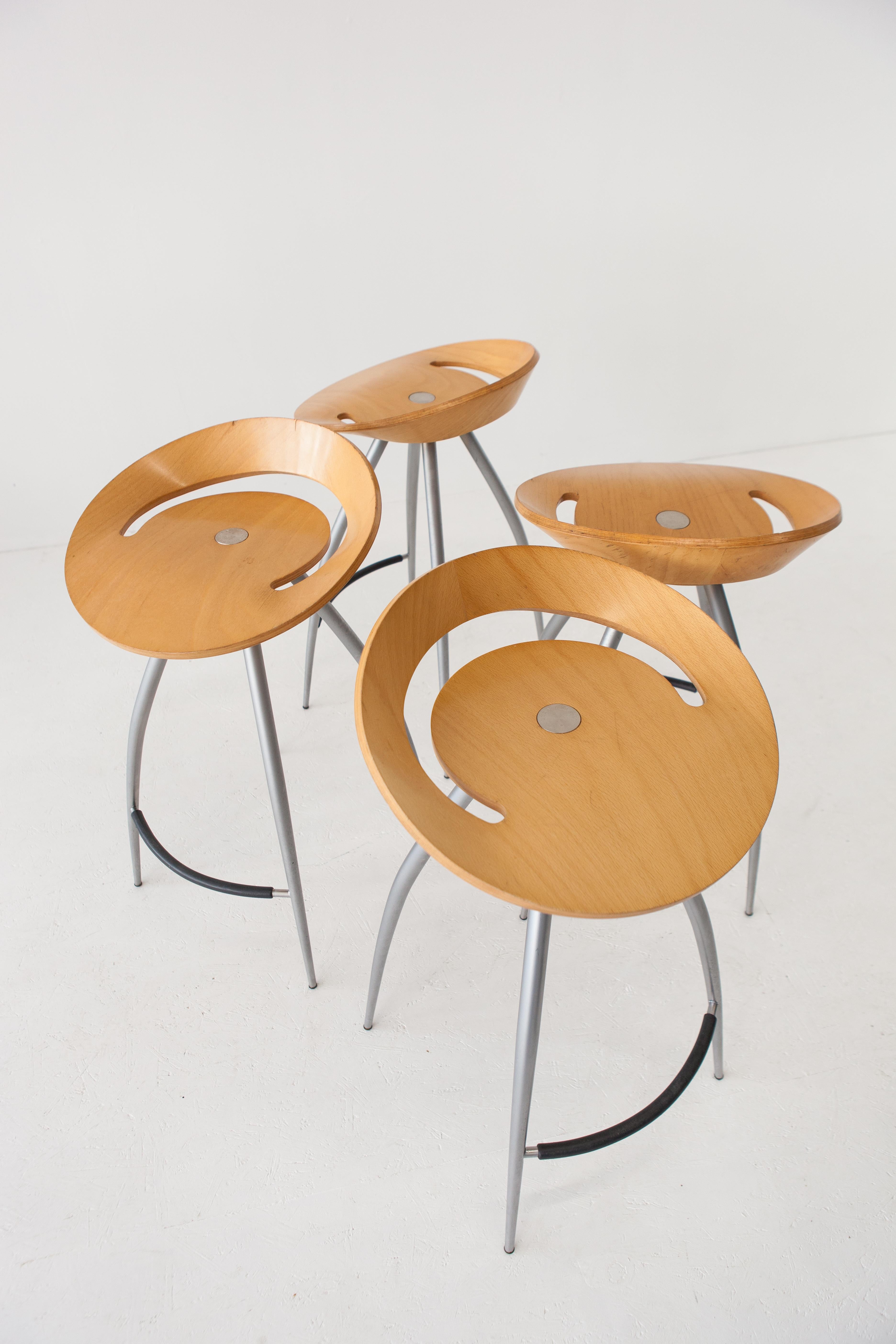 In need of some spice in your bar, restaurant or your own fancy kitchen? Designed in the 1990s by Design Group Italia for Magis, these four Italian bar stools present an iconic spider-like silhouette. The warm-colored bentwood not only contributes