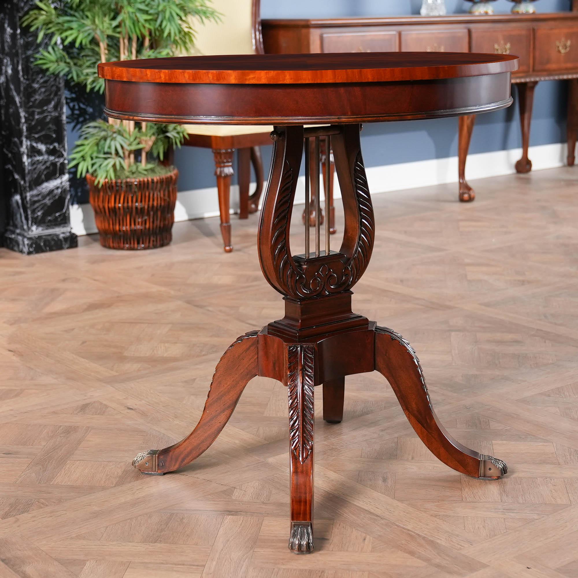 Starting with it’s oval top the Lyre Lamp Table from Niagara Furniture is an exercise in elegance. The sweeping  mahogany base is created in a lyre or harp shaped form are executed in solid mahogany. Hand carved by master craftsmen the base of each
