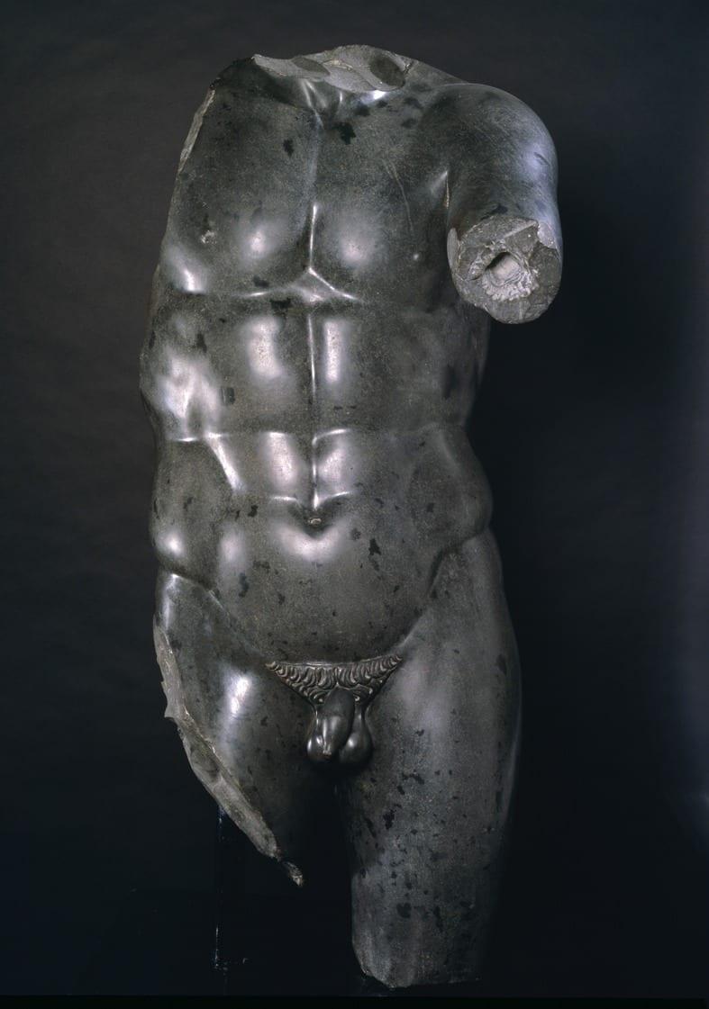An exceptional and well-studied large-scale carving of a torso in black basalt after the Roman antique. Depicted life-sized, standing in contrapposto with his weight on his left leg, the right slightly advanced, the left arm projecting forward, the