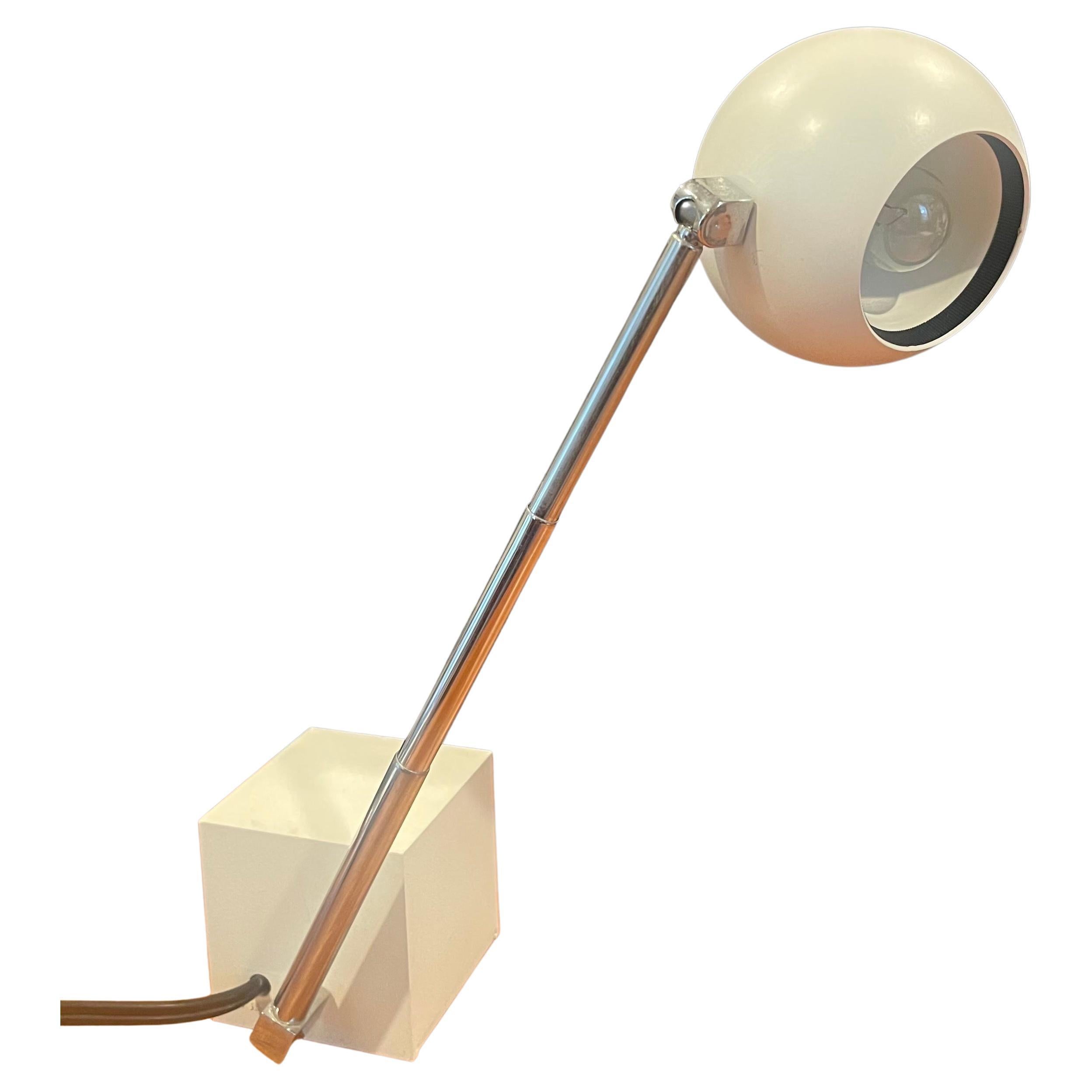 A very nice Lytegem desk lamp in off-white with spherical metal shade, cube base and chrome arm designed by Michael Lax for Lightolier, circa 2000. The lamp was named by the late Industrial designer Jay Doblin as one of the 20th century's hundred