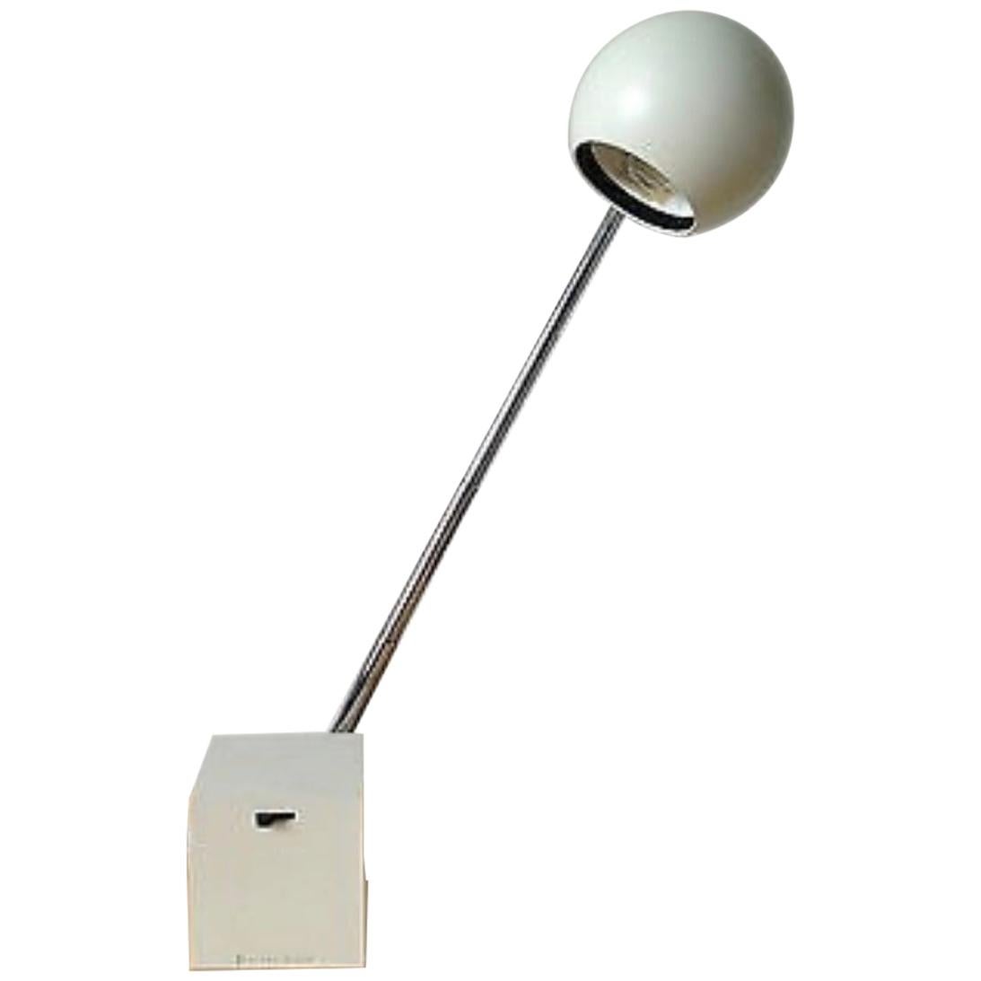 All white Lytegem lamp with spherical metal shade, cube base and chrome arm. Designed by Michael Lax for Lightolier. USA, circa 1990.

Named by the late Industrial designer Jay Doblin as one of the 20th century's 100 great product designs. The