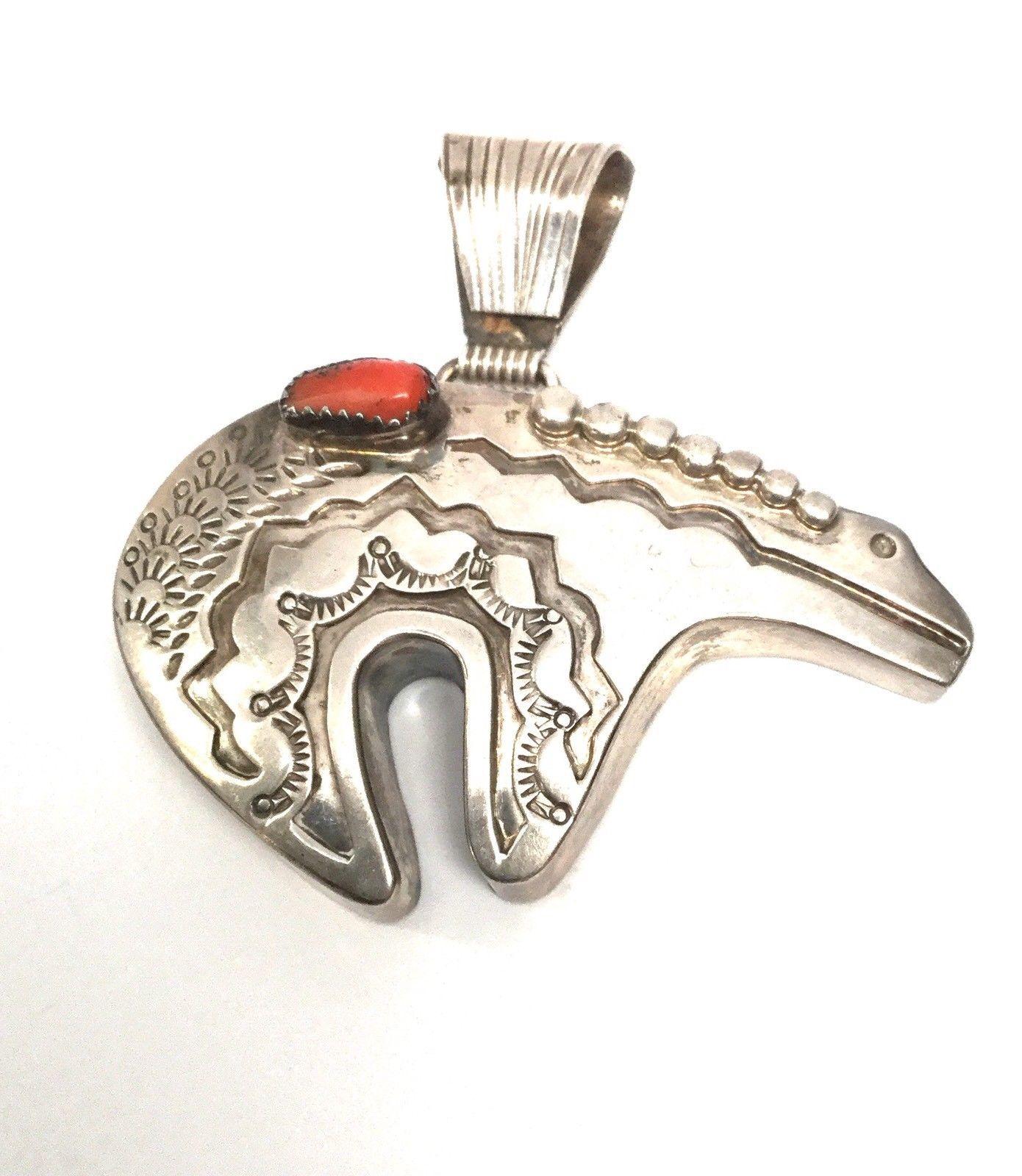 M. Begay Native American Sterling Silver and Coral Bear Pendant

Smoothly polished on the back, this love bear has substantial size yet is lightweight and highly decorated on the front side with a coral stone designed by M. Begay.

Measurements: