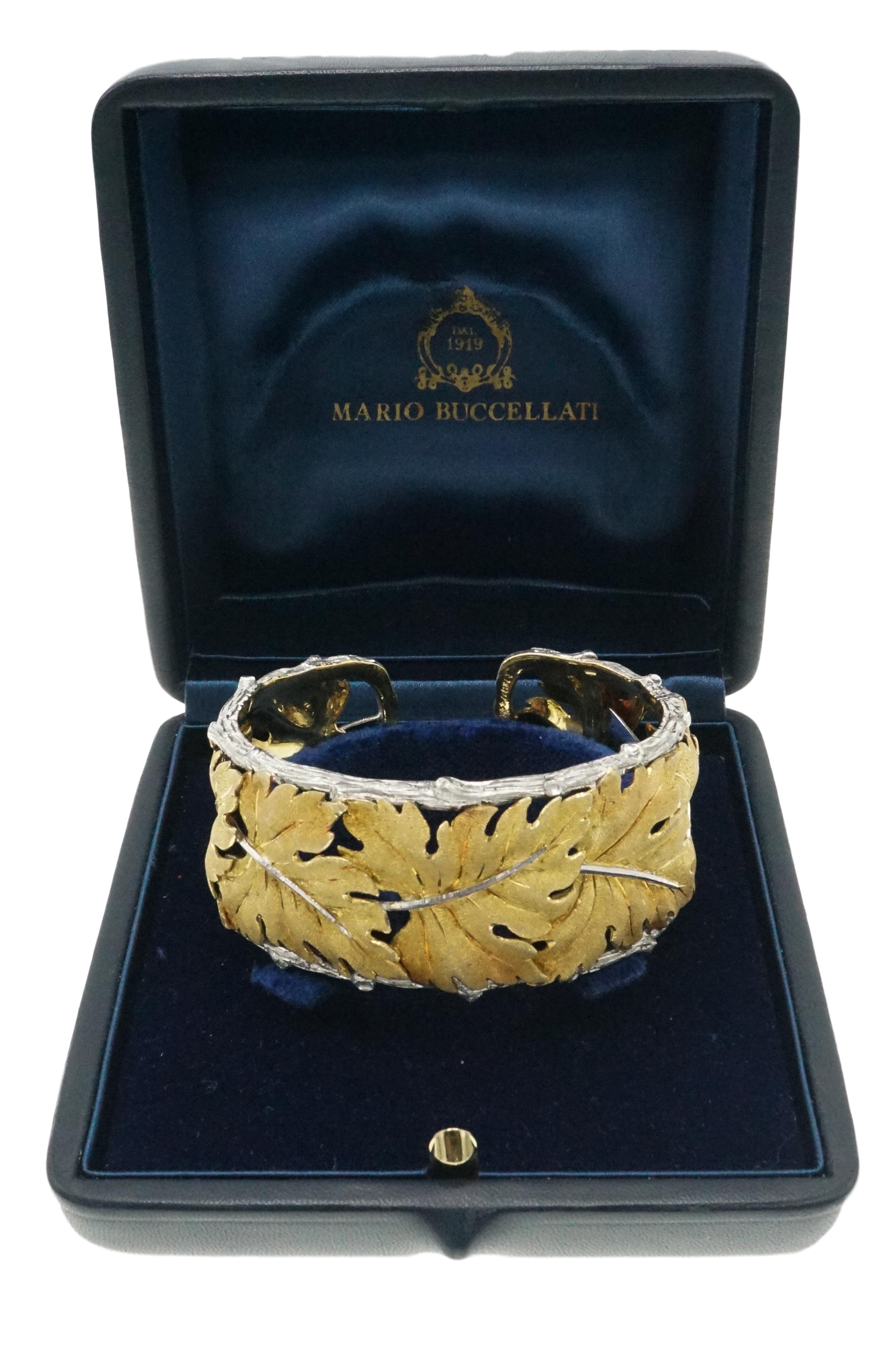 Take a look at this gorgeous two-toned cuff bracelet. Large textured yellow gold leaves wrap around the bracelet while sterling sliver adds a place contrast in the form of high polish stems. The fastidiously detailed border at top and bottom