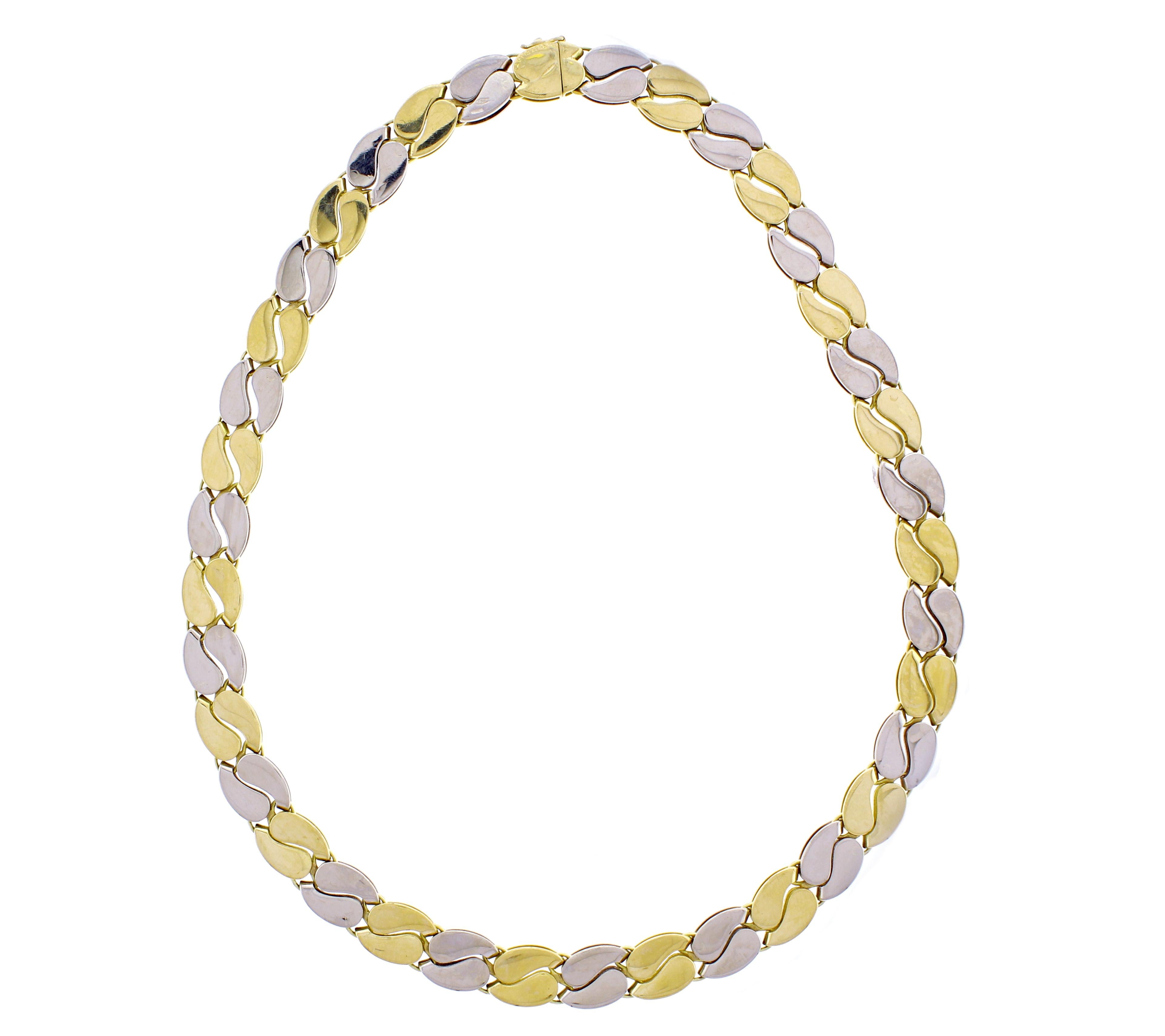 From master jeweler Mario Buccellati, a reversible white and yellow 18 karat gold necklace. One side features Mario Buccellati's iconic textured engraving the other side is high polished. 10mm wide, 16 ¼ inches long,  95 grams. Hand signed M.