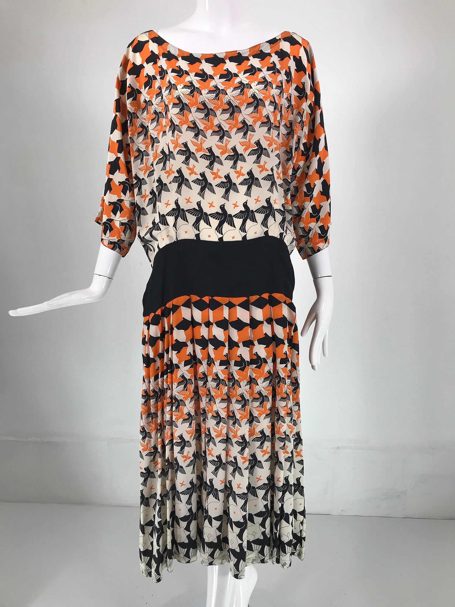 M C Escher tessellated silk print dress by Loretta Di Lorenzo, Italy from the 1980s. Birds & fishes ascending design in black, orange and white silk. Open neck dress, kimono sleeves with a wide black silk hip band that ties at the back or wraps to