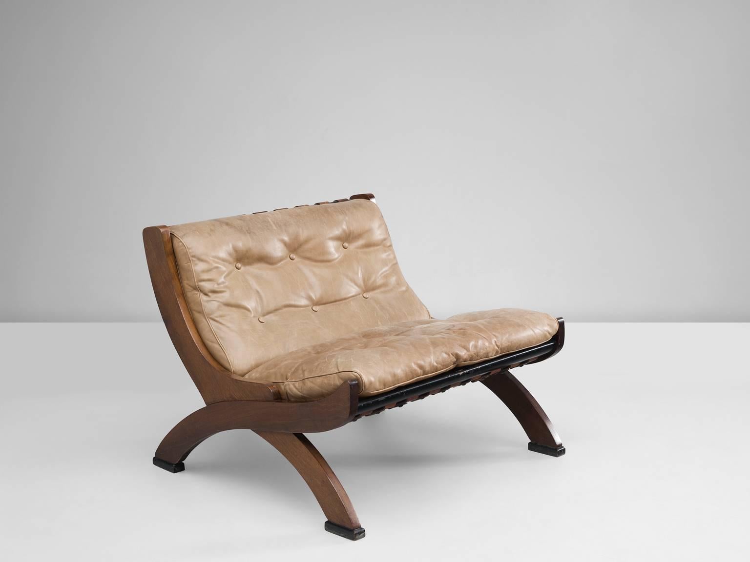 Lounge chair, in walnut and leather, by M. Comolli for I.C.F. De Padova, Italy, 1960s. 

This great lounge chair has a beautiful all-over patina. Highly comfortable due to down filling and well-designed proportions. The back shows nice cognac