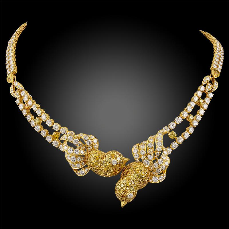 A remarkable and chatoyant suite by M. Gerard comprising a necklace, ring and ear clips designed as bird motifs, finely crafted in 18k yellow gold, adorned with an opulence of fancy yellow and white diamonds throughout. The fancy yellow diamonds