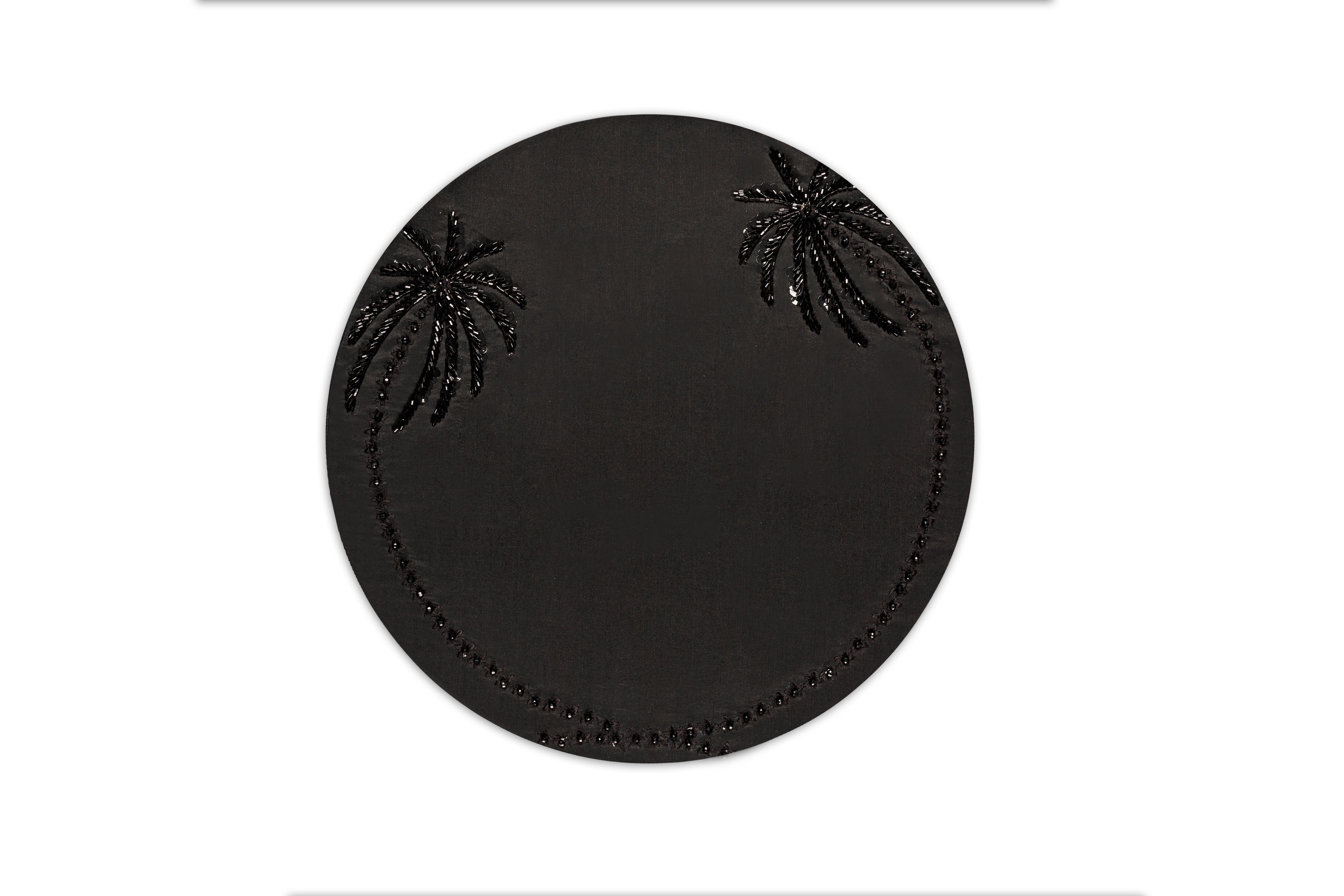 All hand made, Les Palmier placemat marries two palm trees to create a magnificent halo around your dinnerware. The trunks are intricately embroidered with black threads while the palm leaves are fashioned with beadwork.
