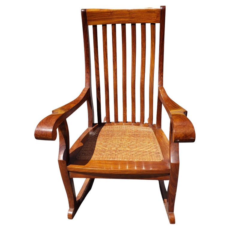 Exquisite Anglo-Indian Hardwood woven seat rocking chair by M Hayat and Brothers in Peshawar. 
Very good vintage condition. Double lacquered. Measures 
Arm height is 26.5