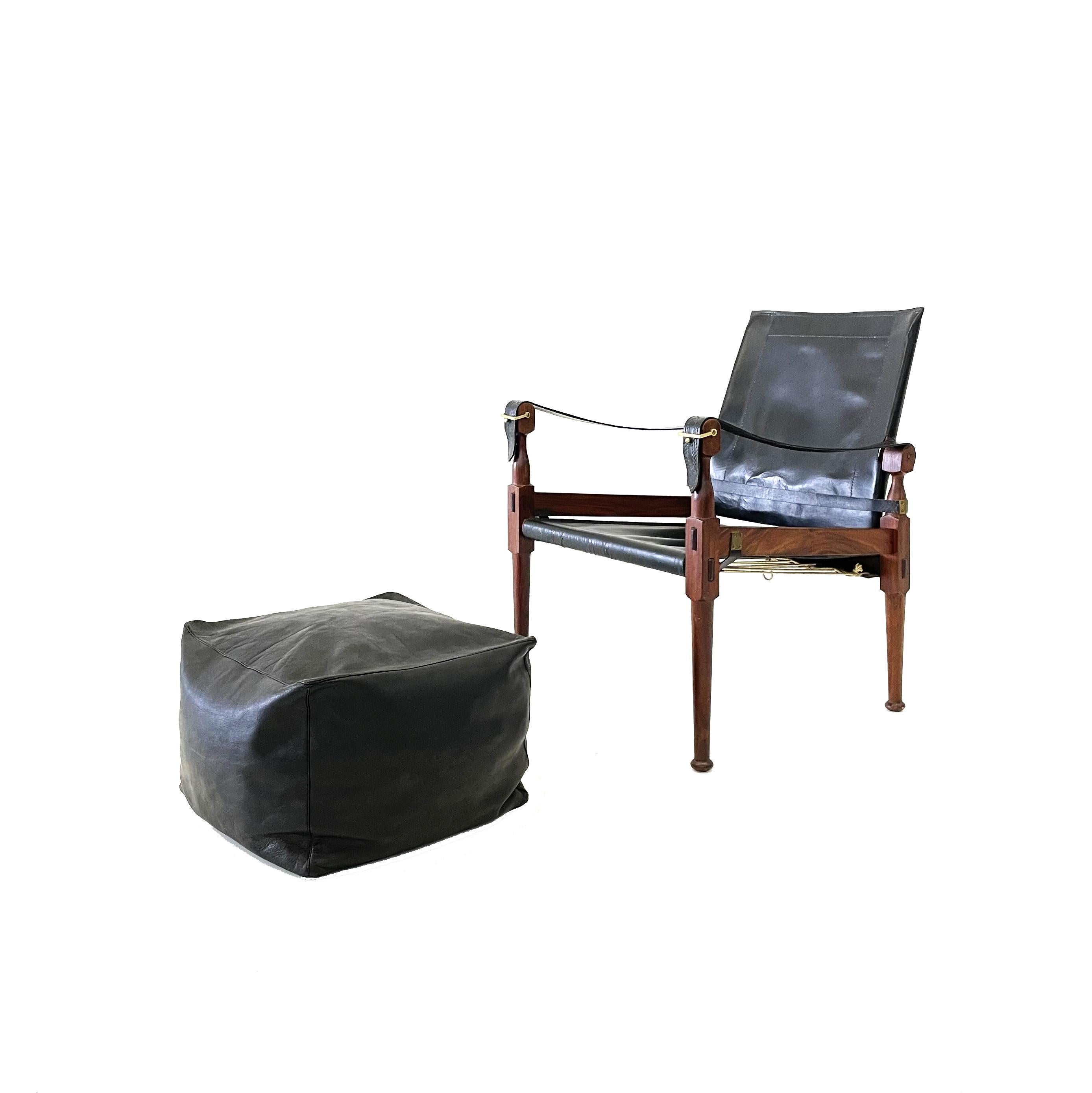 'Safari' lounge chair and ottoman, wood, black leather and brass, Pakistan, 1970s

This 'Safari' armchair shows very elegant and well designed lines, in combination with carefully crafted wood joints. The black leather with multiple straps completes