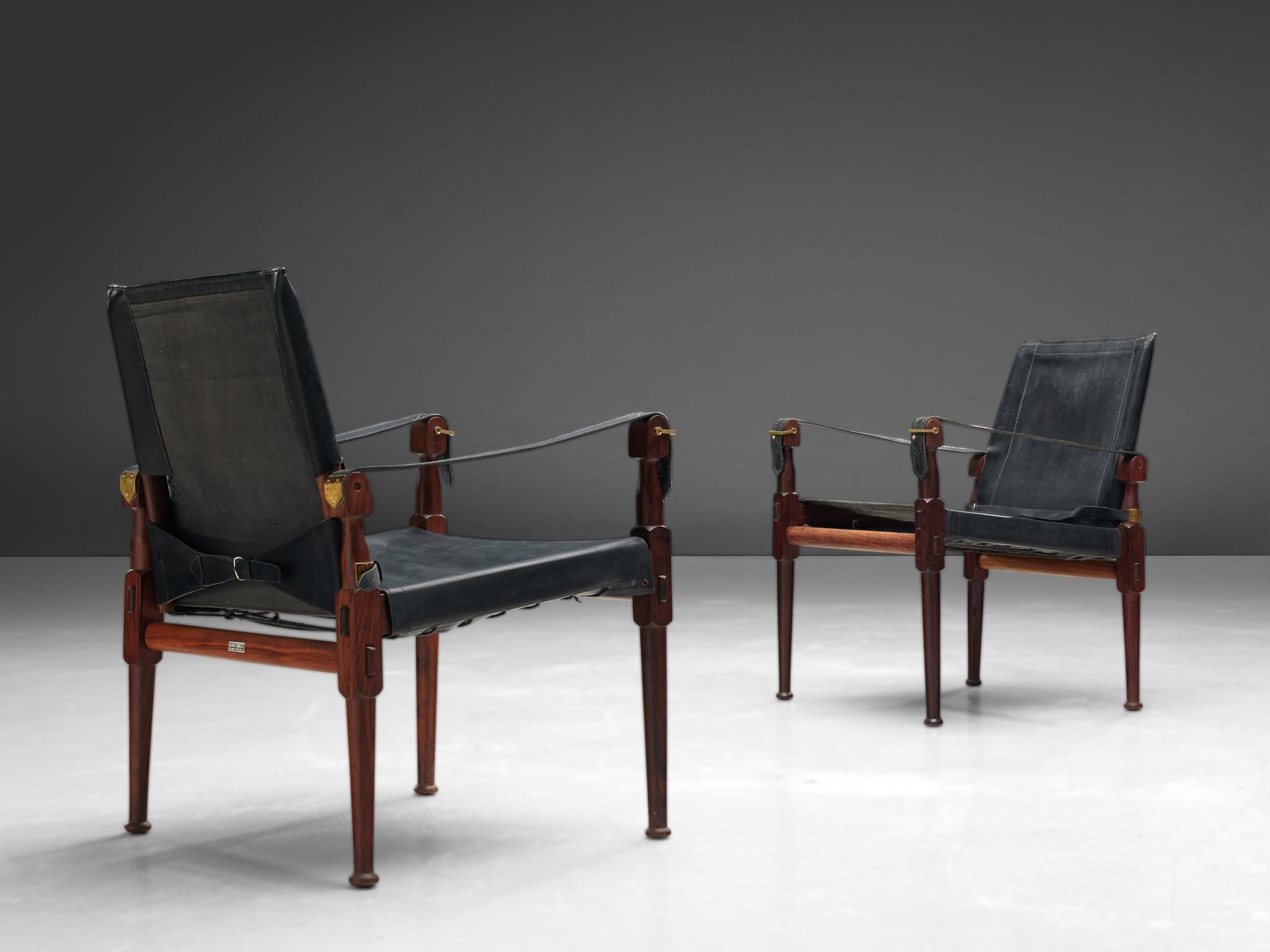 Wonderful 'Safari' lounge chairs, wood, black leather and brass, Pakistan, 1970s.

This 'Safari' armchair shows very elegant and well designed lines, in combination with carefully crafted wood joints. The black leather with multiple straps completes