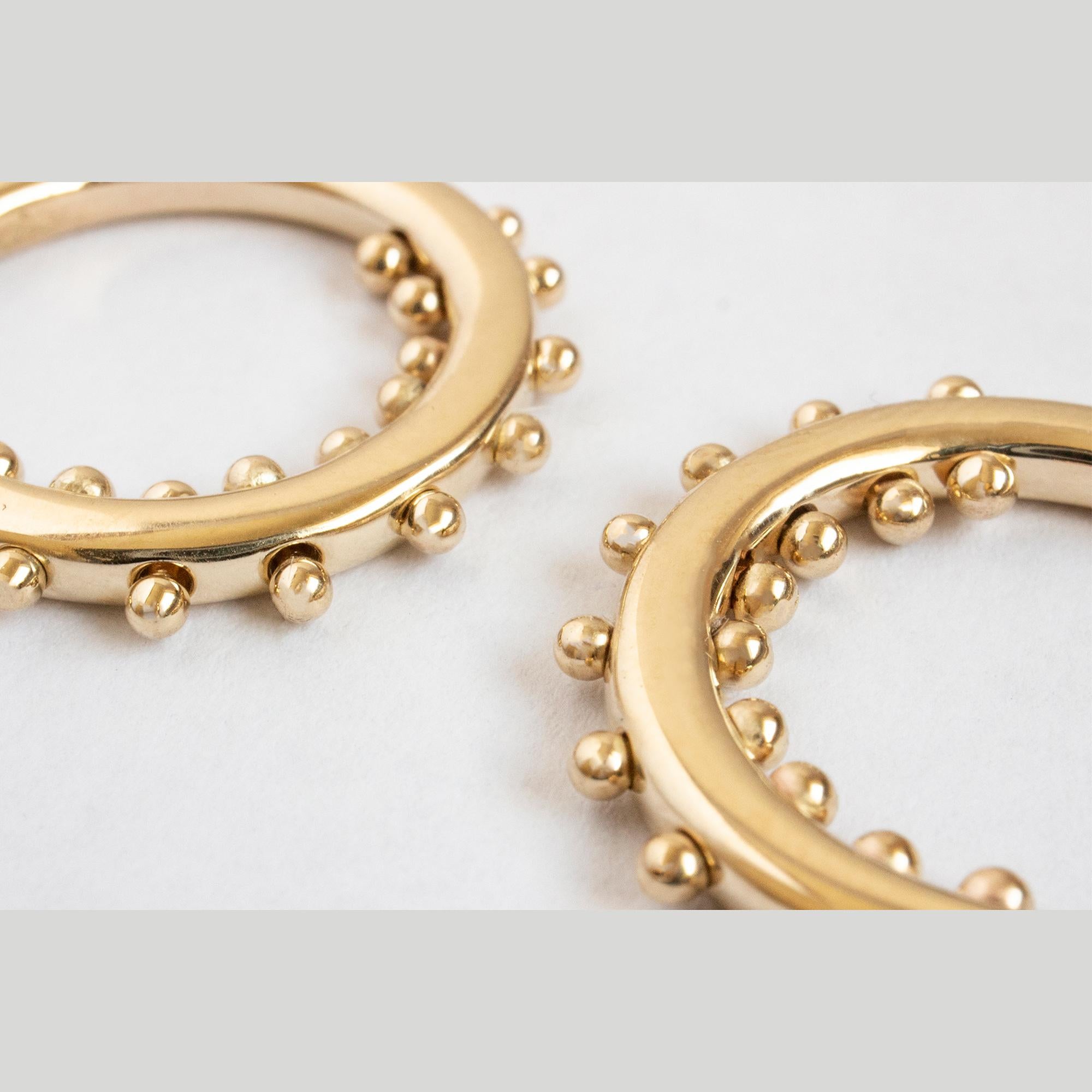 Here, beaded elements reminiscent of the ancient technique of granulation. The beads create an eye-catching update on your classic hoop.

14K YELLOW GOLD PAIR
READY TO SHIP

MATERIAL
◘  2mm wide hoop, 16mm outside diameter
◘  9x hand-balled beads