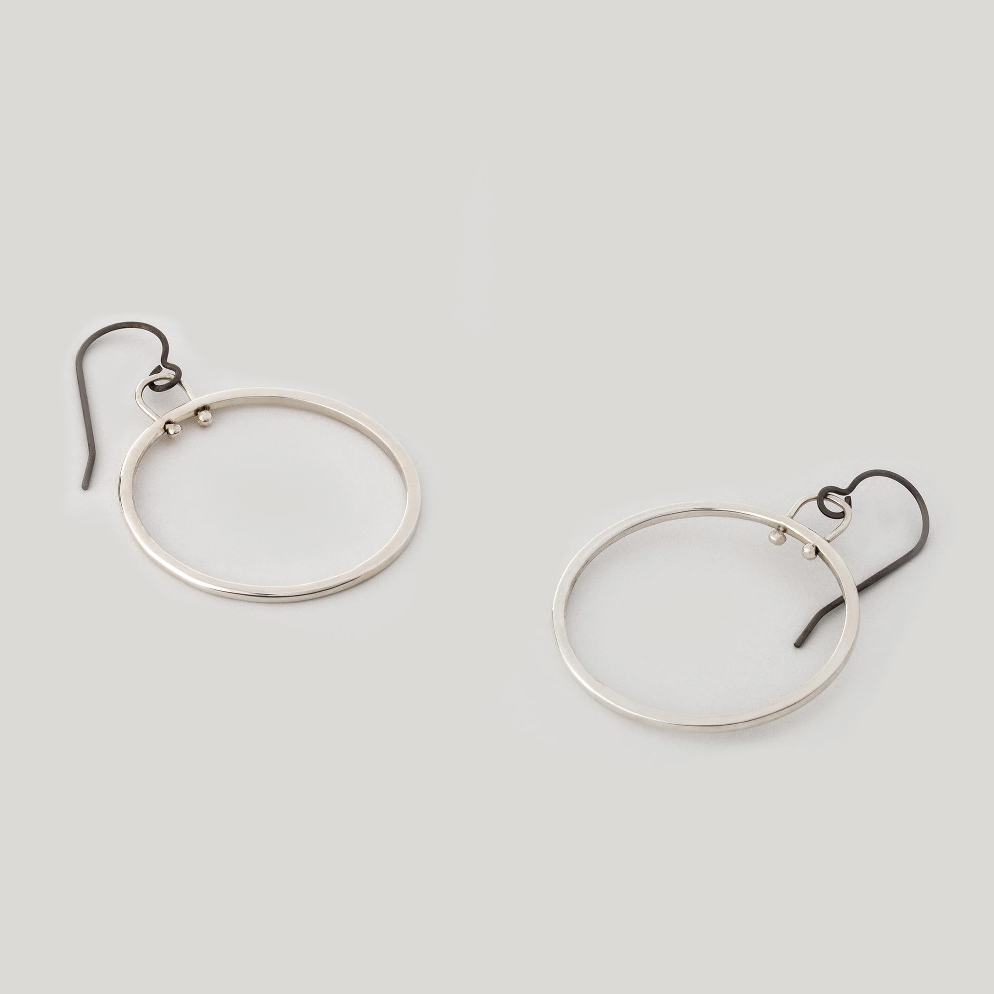The dynamic hoop, an M. Hisae signature. Round and square wire is joined seamlessly. A beautiful genesis of movement out of static, minimalist forms.

MATERIAL
◘  Approx. 1in round
◘  Large hoop joins round and square wire
◘  Hung on hypo-allergenic