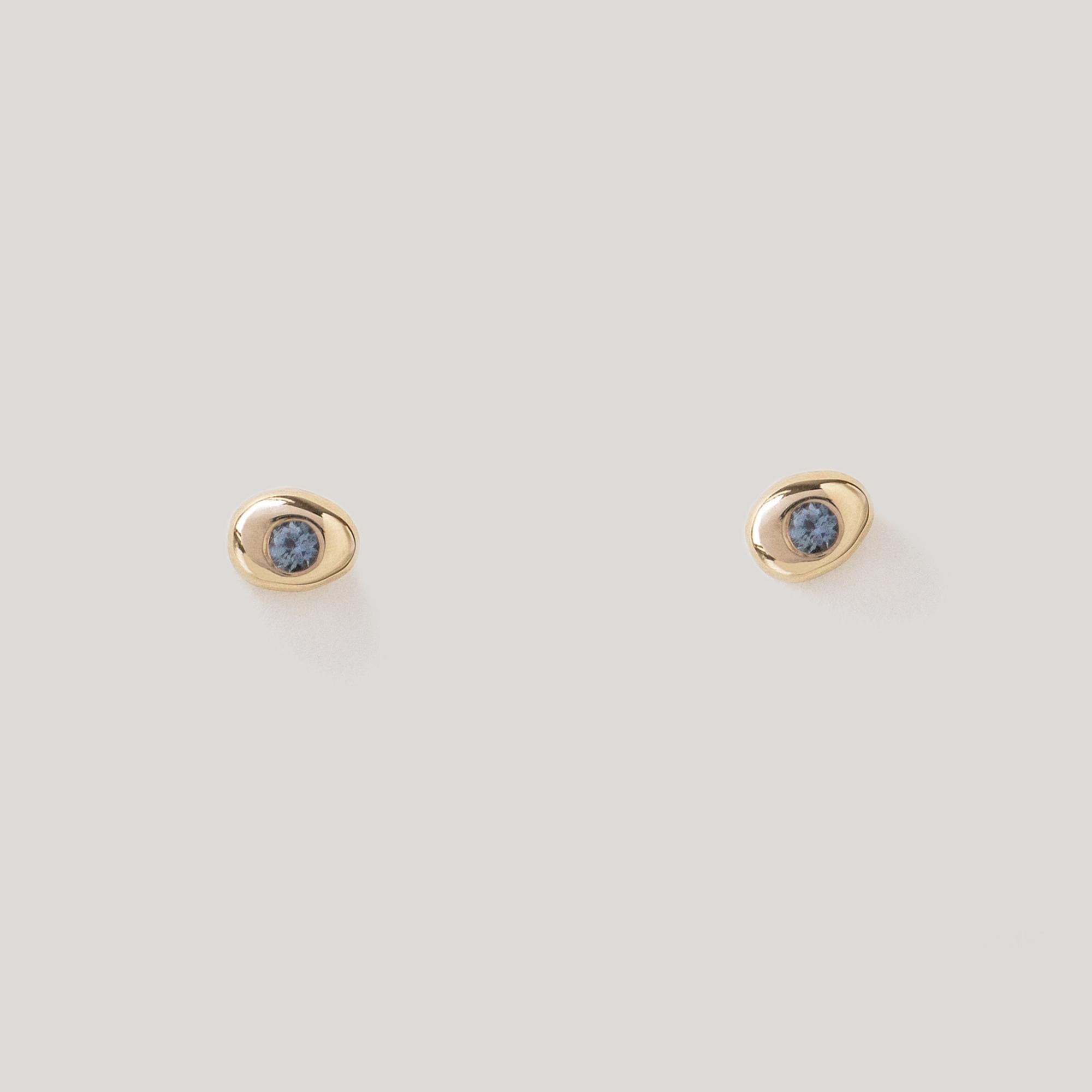 Tender little pebble studs, pierced with a Teal Sapphire center.

MATERIAL
◘  4mm wide by 5.5mm tall
◘  2mm brilliant-cut Teal Sapphire
◘  Sapphires are fair trade and sourced responsibly
◘  Post and back closure
◘  Sold as a pair
◘ Available in 14k