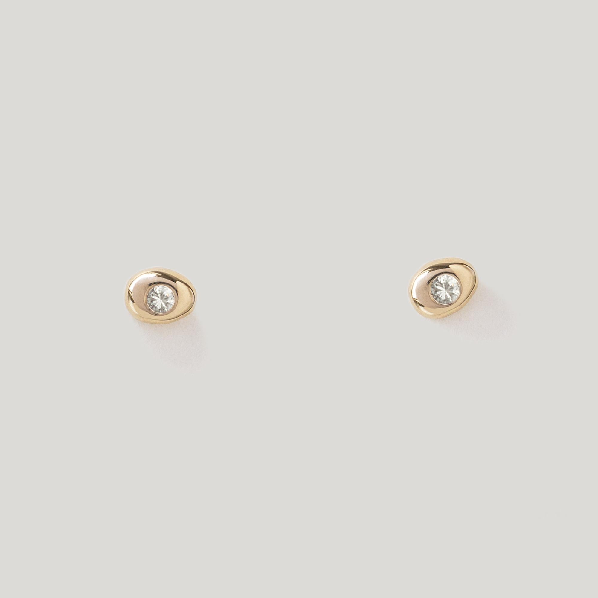 Tender little pebble studs, pierced with a White Diamond eye.

MATERIAL
◘  4mm wide by 5.5mm tall
◘  2mm brilliant-cut White Diamond (SI)
◘  Diamond is reclaimed and fair trade
◘  Post and back closure
◘  Sold as a pair
◘ Available in 14k Yellow,