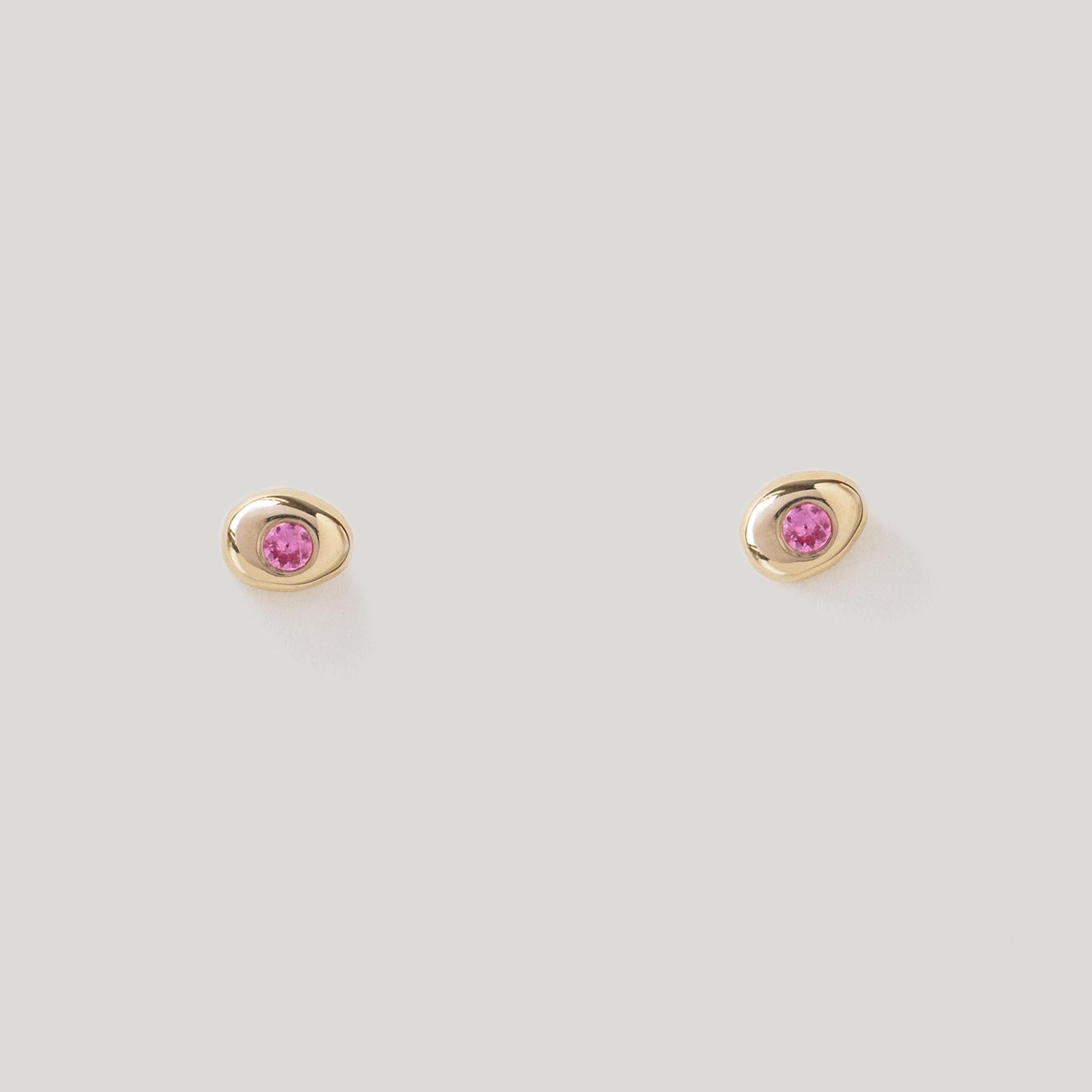 Tender little pebbles, pierced with a Pink Sapphire center.

14K YELLOW GOLD PAIR
READY TO SHIP

MATERIAL
◘  4mm wide by 5.5mm tall
◘  2mm brilliant-cut Pink Sapphire
◘  Sapphires are fair trade and sourced responsibly
◘  Post and back closure
◘ 