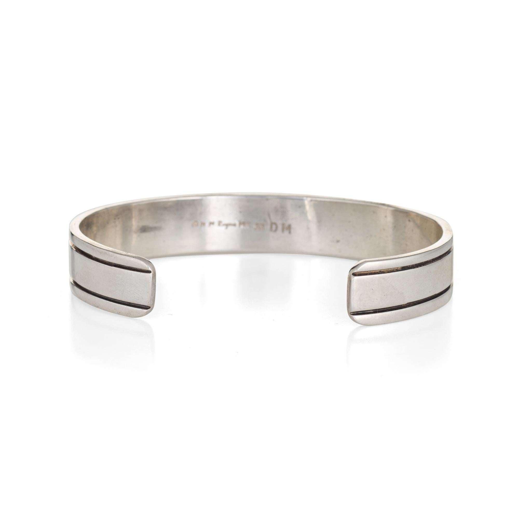 Stylish and finely detailed M. M. Rogers estate cuff bracelet crafted in sterling silver with 14k yellow gold accents.  

The cuff features a textured design to the center of the cuff in 14k yellow gold. The bracelet is great worn alone or layered