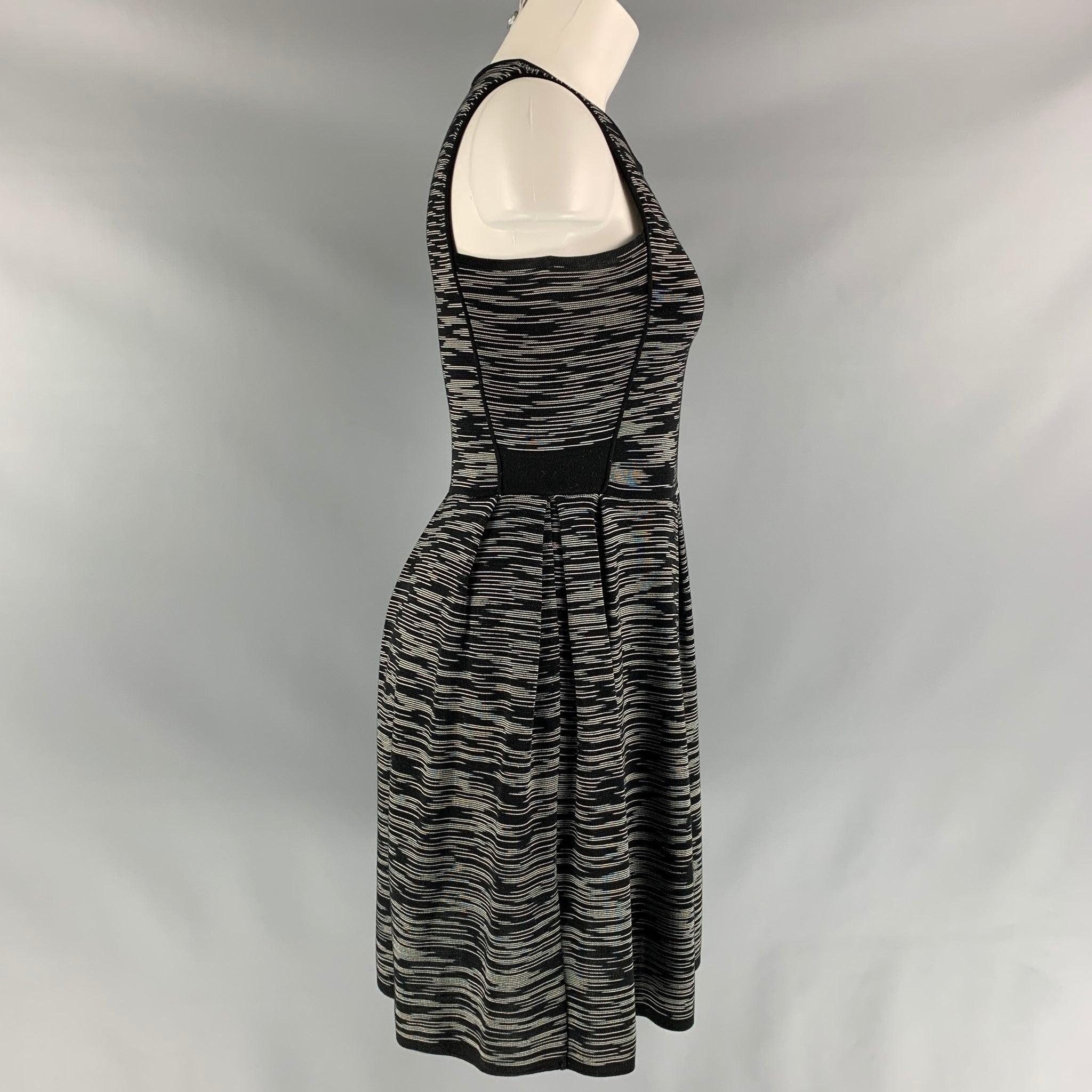 M MISSONI sleeveless A-lined dress comes in a black and white knitted fabric and full lining.
Very Good Pre-Owned Condition. Fabric Tag Removed. 

Marked:   40  

Measurements: 
 
Shoulder: 12 inBust: 32 inWaist: 28 inHip: 34 inLength: 36 in

  
  
