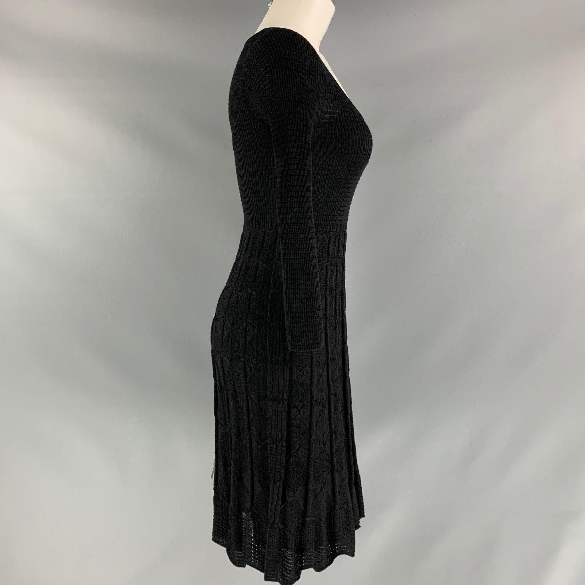 M MISSONI 3/4 sleeve A-line dress comes in black knitted fabric and removable slip lining.
 Made in Italy.Very Good Pre-Owned Condition. Fabric Tag Removed. 

Marked:   42  

Measurements: 
 
Shoulder: 15 inBust: 26 inWaist: 25 inHip: 33 inSleeve: